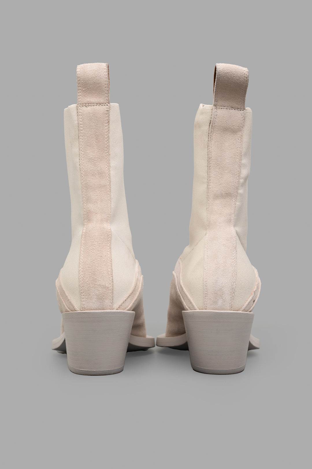 Mattia Capezzani suede boots showcasing a sculptural ecru design, featuring unique back details and sturdy heels.