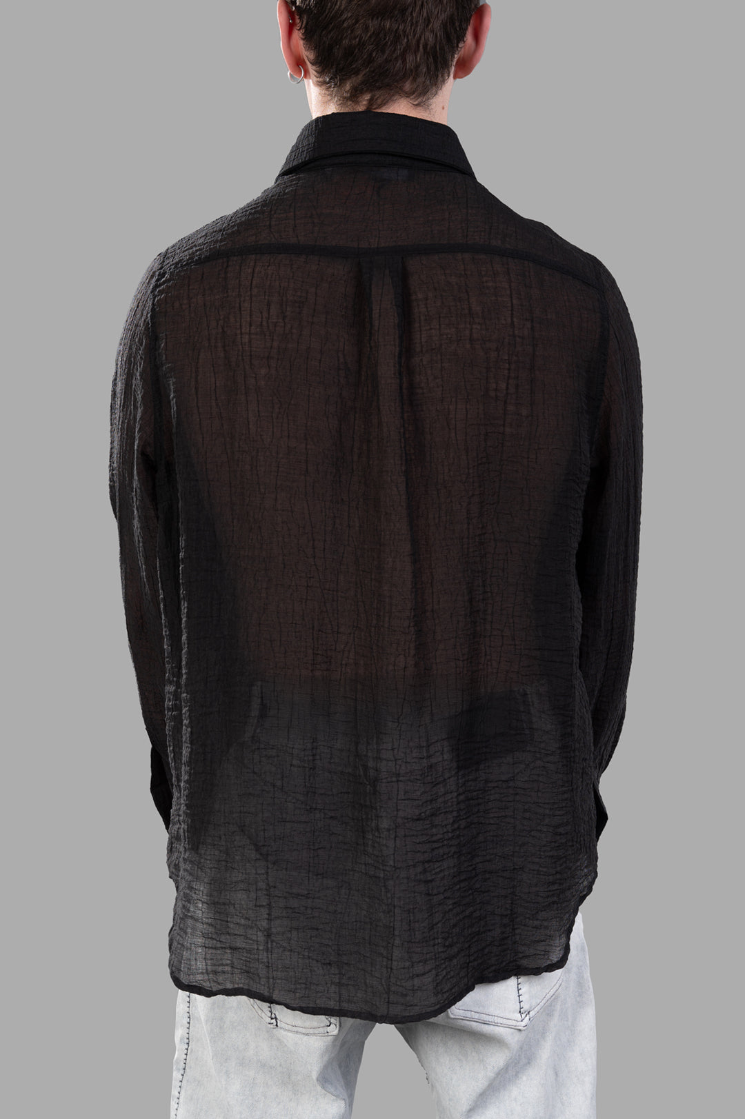 Justin Gall Crinkled Shirt seen from behind, featuring a semi-transparent texture and relaxed-fit silhouette in black.