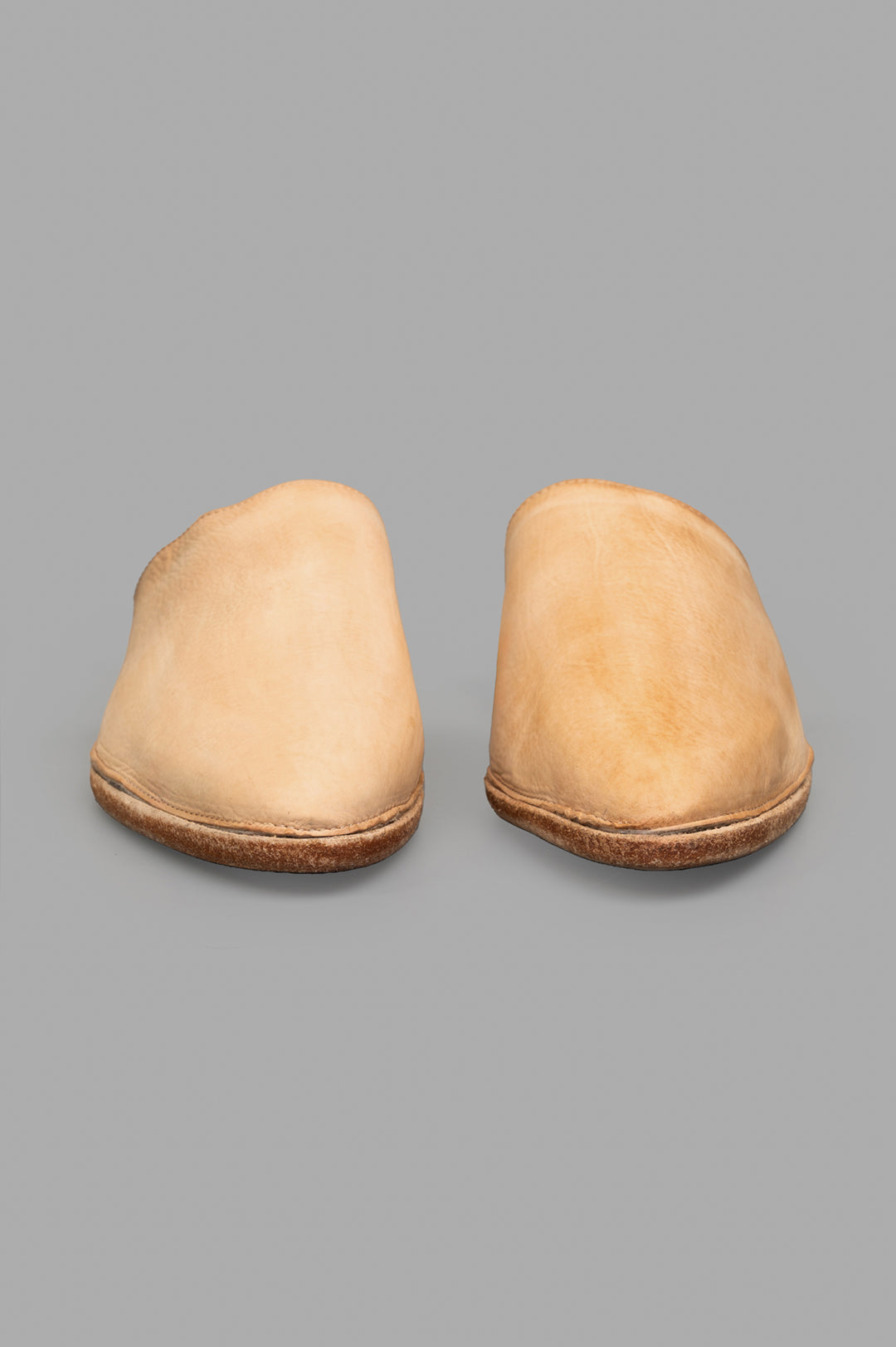 Shoto. Beige Leather Mules showcasing a clean front view, handcrafted from natural leather with unique patina.