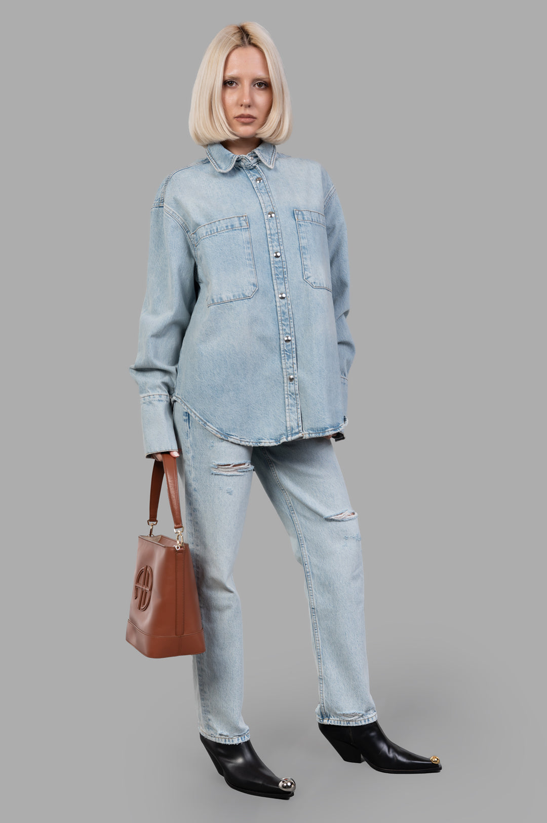 Anine Bing Dante Denim Shirt styled on-model, showcasing front pockets and snap buttons in light blue vintage wash.