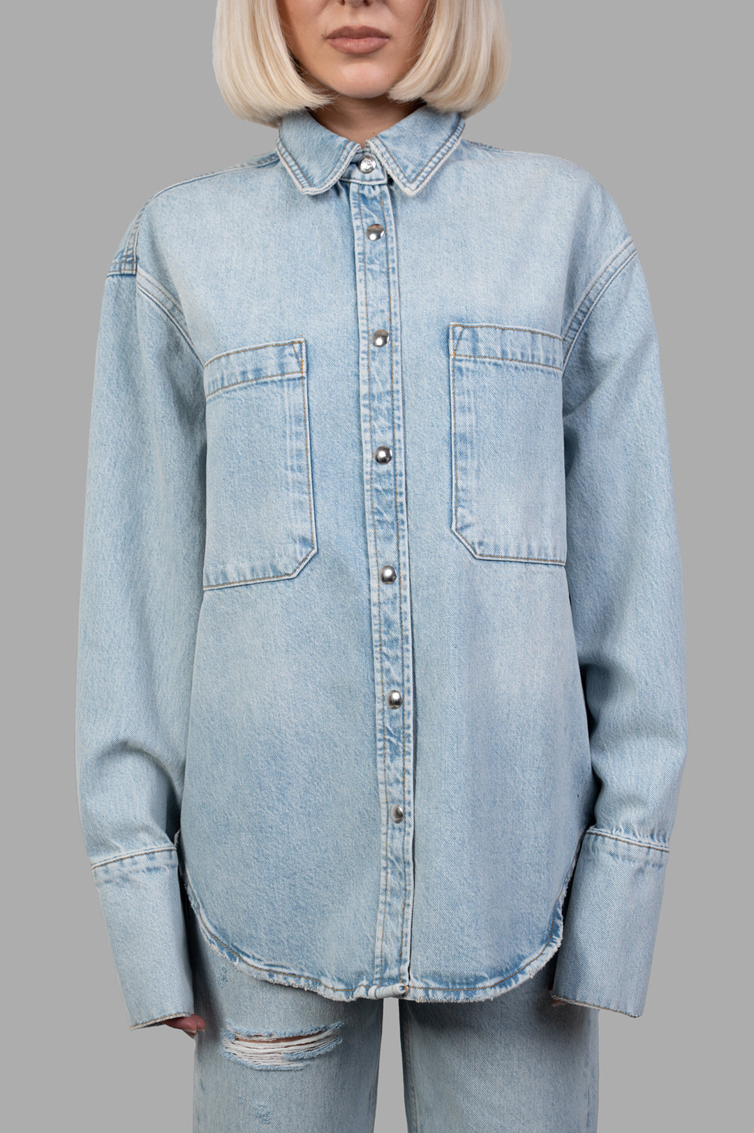 Anine Bing Dante Denim Shirt in bleached blue, showcasing oversized fit, front pockets, and signature snap buttons.