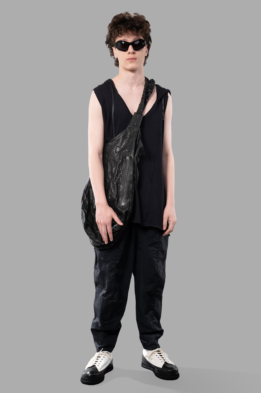 Justin Gall Light Rib Hooded Cutoff shown on model with raw cut hem and waxed drawstring in soft black fabric.