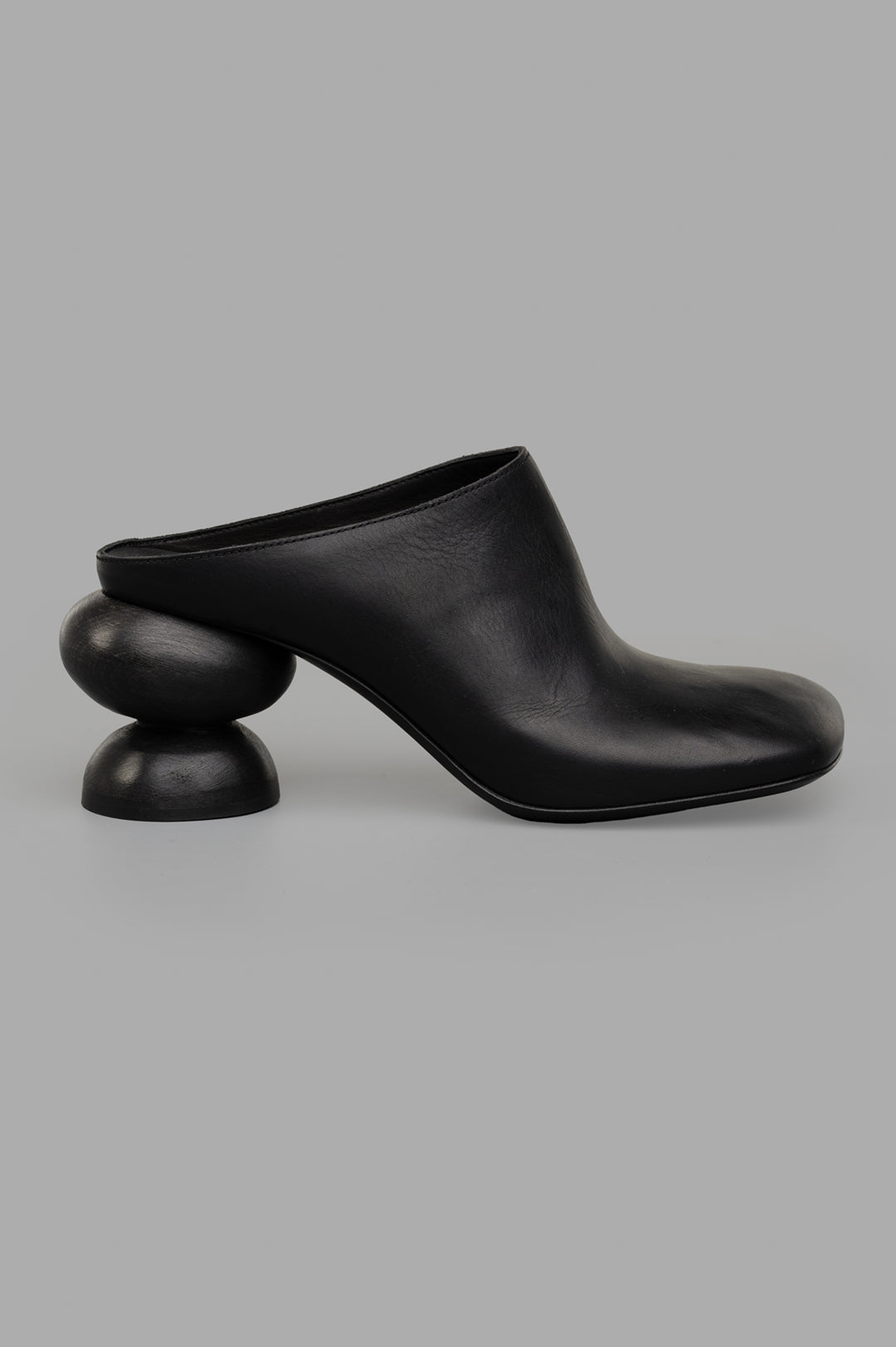 Uma Wang Stone Mules in Black, side view showcasing square toe and unique double-ball heel, crafted in calf leather.