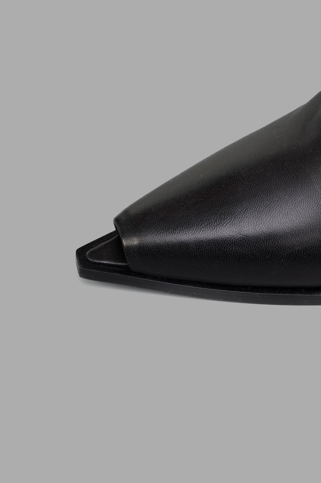 Mattia Capezzani Wedge Mules close-up of sleek black leather design showcasing sculptural toe shape and refined texture.