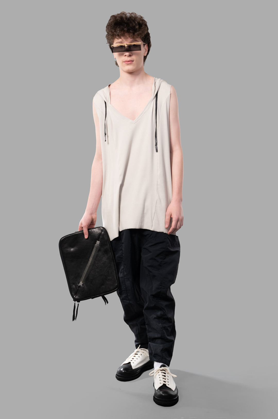 Justin Gall Light Rib Hooded Cutoff on-model, beige, V-neck, raw cut hem, waxed drawstring, bamboo cotton blend.