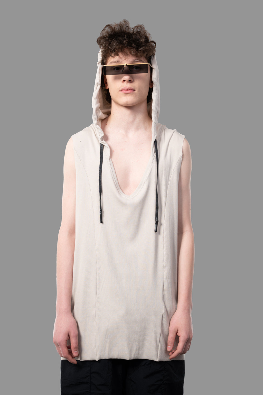 Justin Gall Light Rib Hooded Cutoff in beige, showcasing soft bamboo-blended cotton with a deep V-neck and raw cut hem.