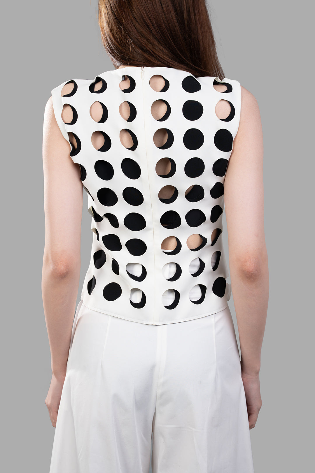 A.W.A.K.E. MODE Top with Layered Holes, showing back view with layered cut-out detailing on a white slim silhouette design.