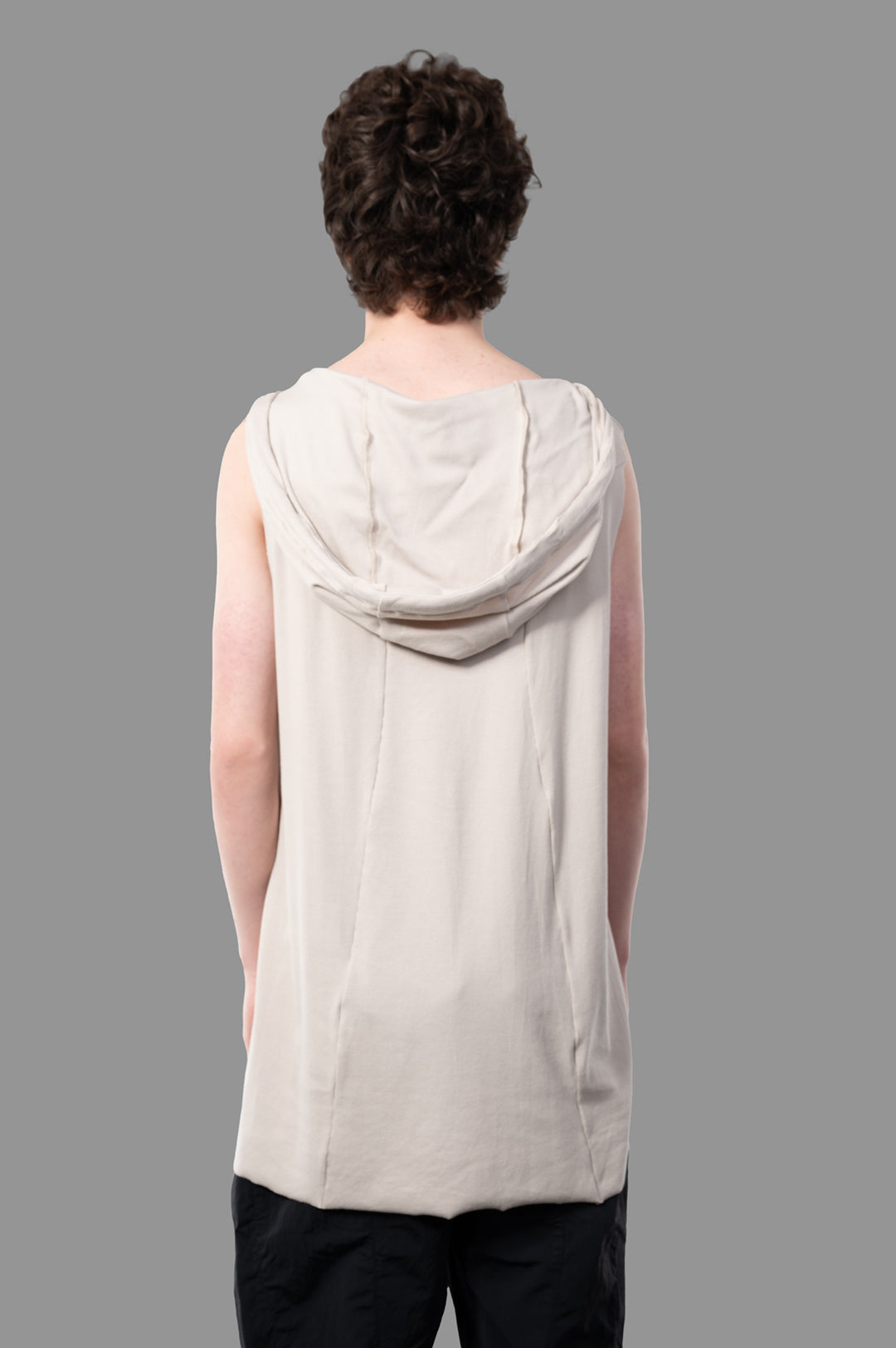 Justin Gall Light Rib Hooded Cutoff shown from the back, featuring a soft beige bamboo-blended cotton fabric and raw cut.