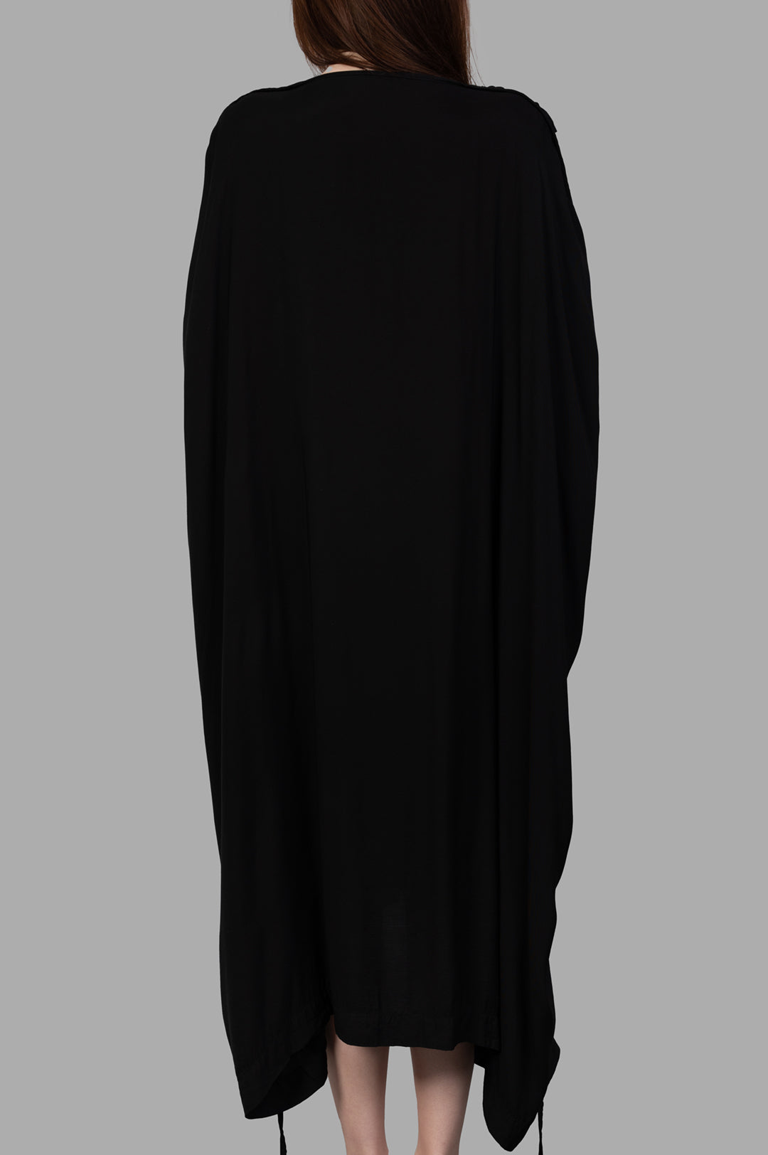 Isaac Sellam. Leather-detail Dress showcased from the back, featuring flowing fabric and sleek high-low design in black.