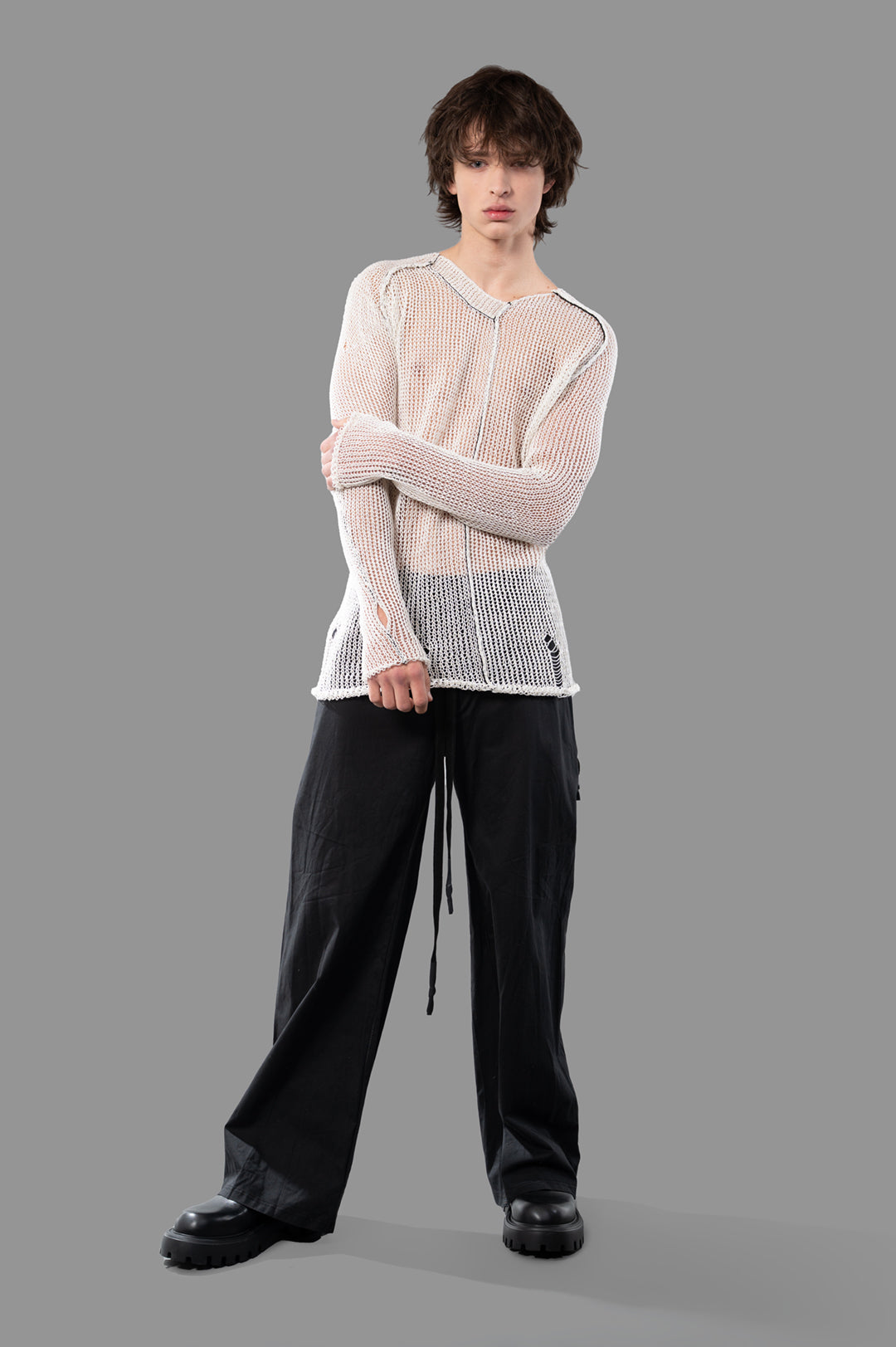 Masnada White Mesh Sweater on model, front view showcasing see-through ecru linen design with a post-apocalyptic style.