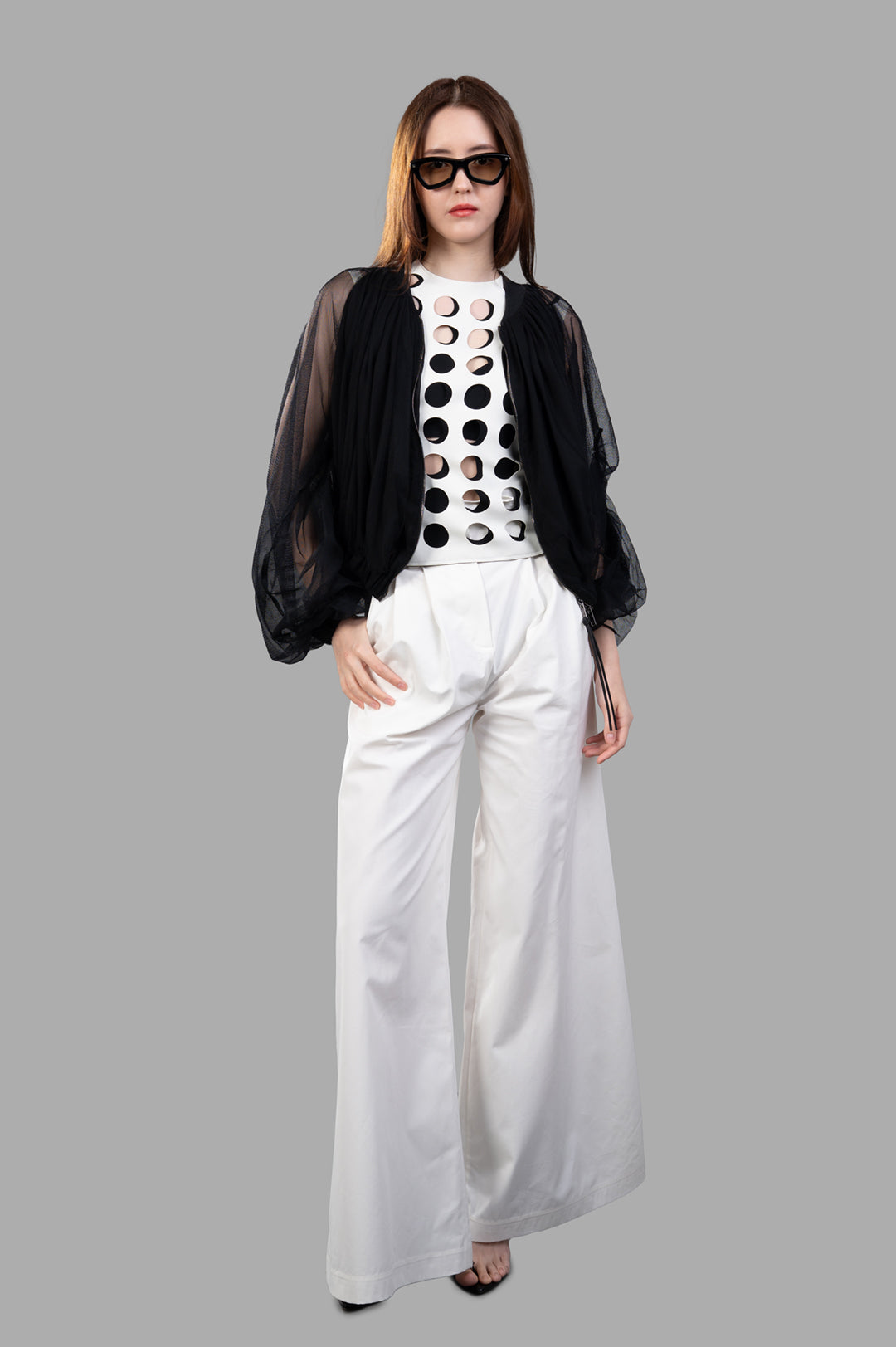 Giovanni Cavagna Mesh Bomber Jacket in black silk, front view on model, emphasizing innovative and cultural design.