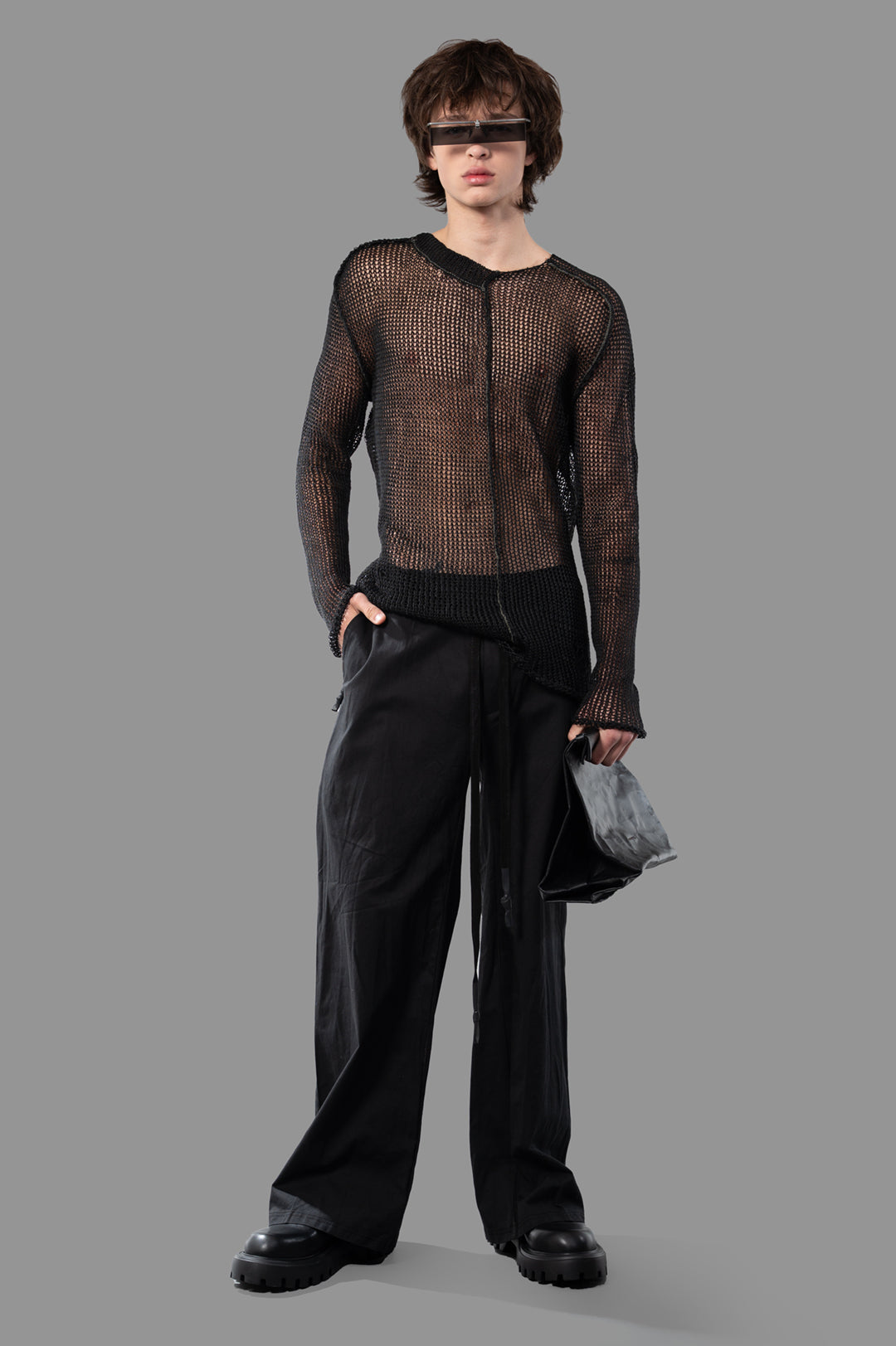 Isaac Sellam wide-leg trousers in black, front view on-model, showcasing the sleek, architectural cut with innovative.