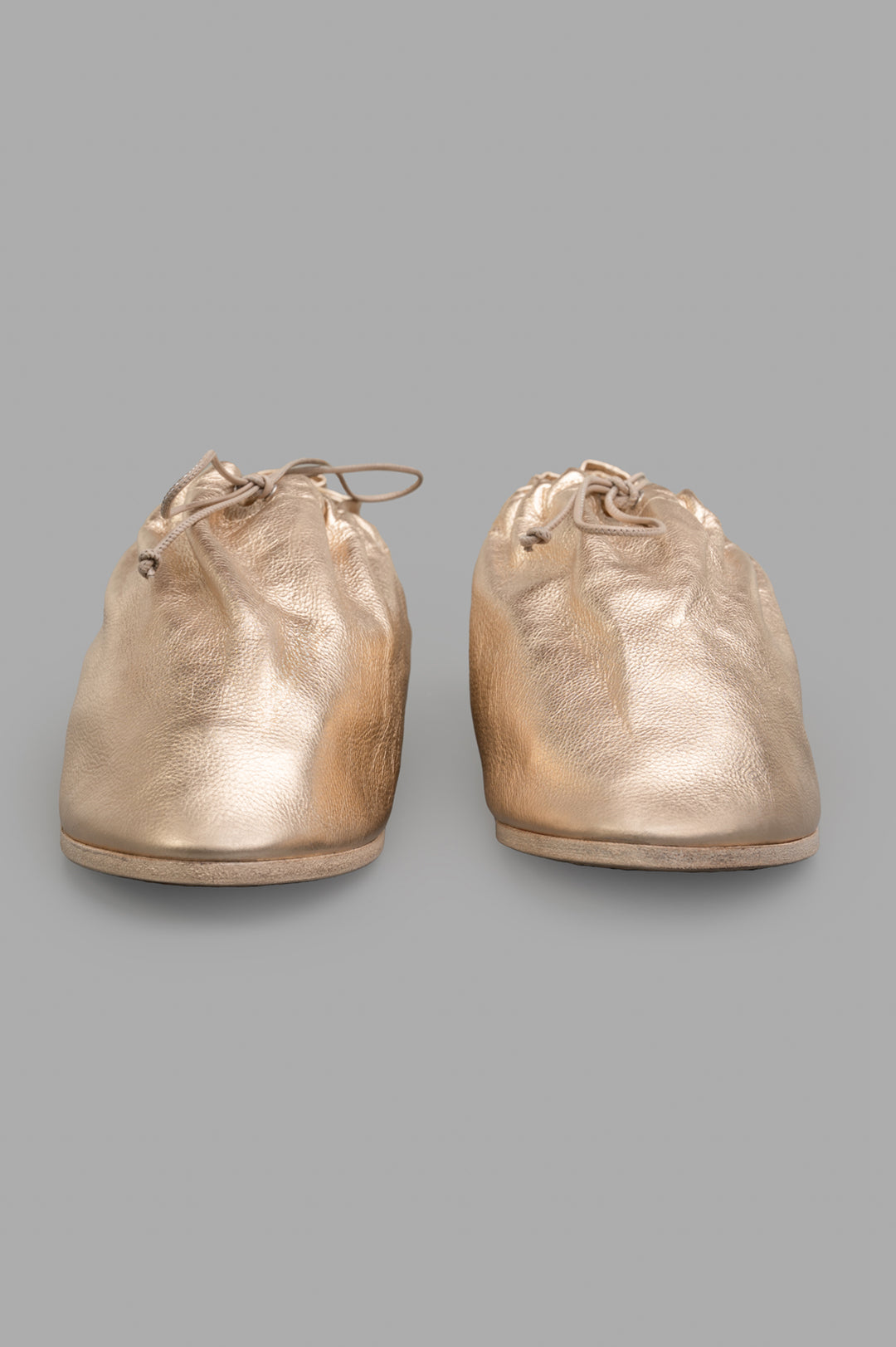 Marsèll Drawstring Shoes in gold, showcasing a handcrafted leather design with a unique texture and drawstring closure.