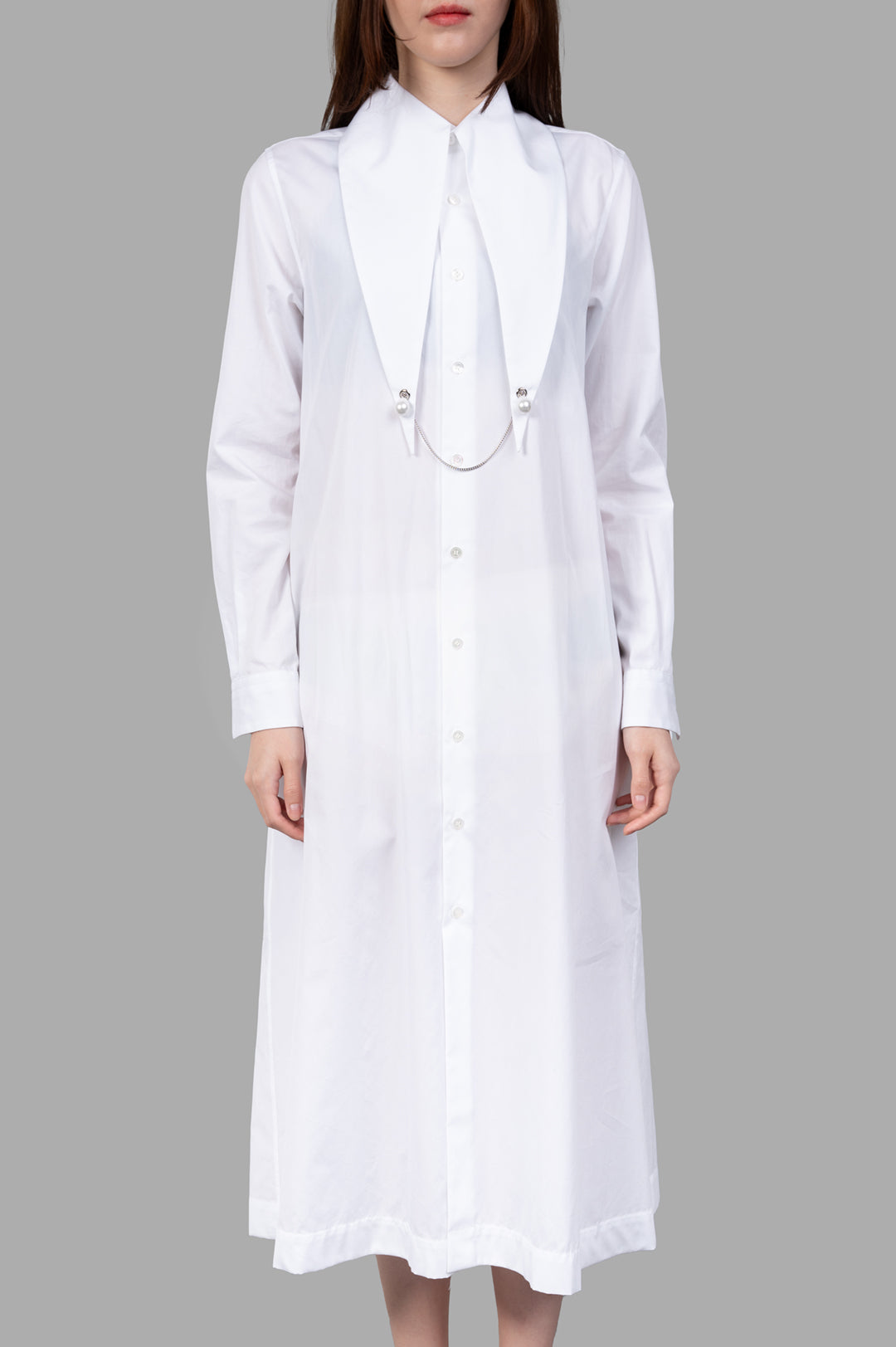 Noir Kei Ninomiya Charm-collar Shirt Dress in white, showcasing an exaggerated collar with pearl charm detailing.