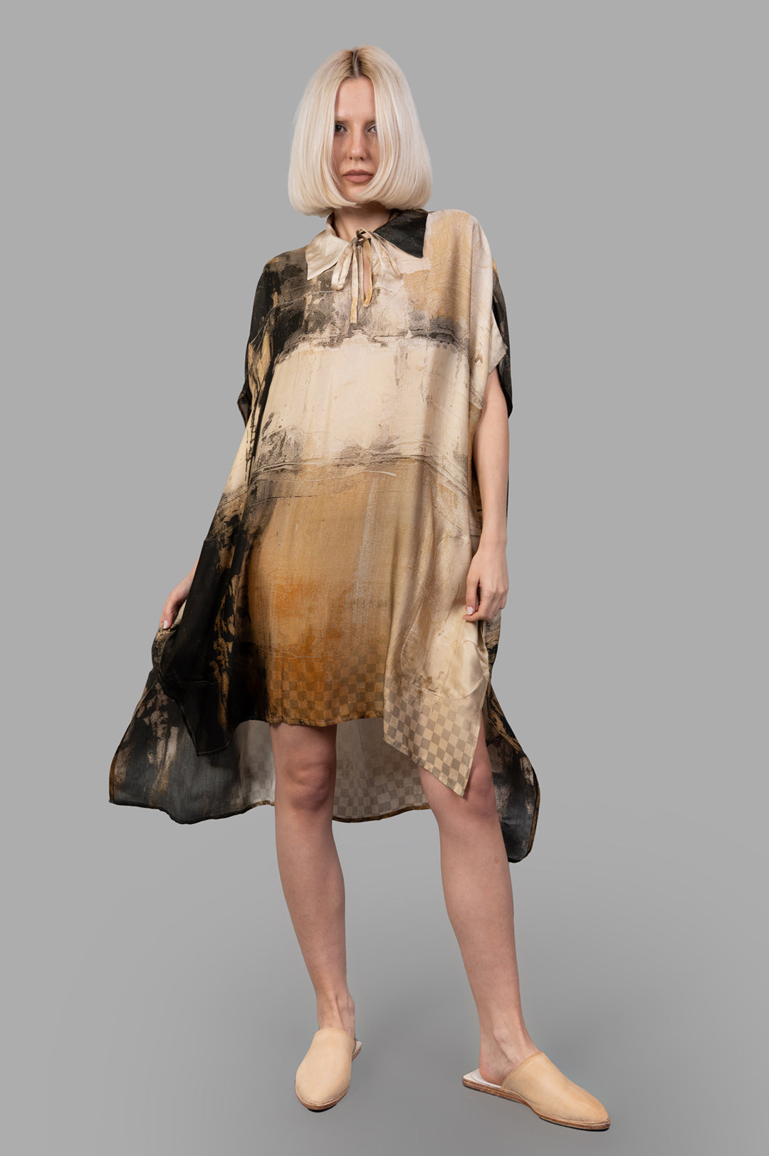 Masnada Abstract-print Dress on-model front view, tie-neck kaftan silhouette in beige-black with side slits and asym hem