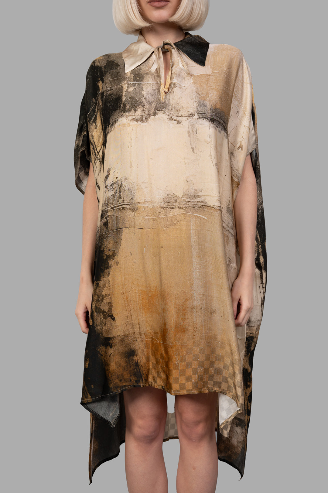 Masnada Abstract-print Dress, front view on model; tie-neck, draped sleeves, beige/black tones, asymmetric hem.