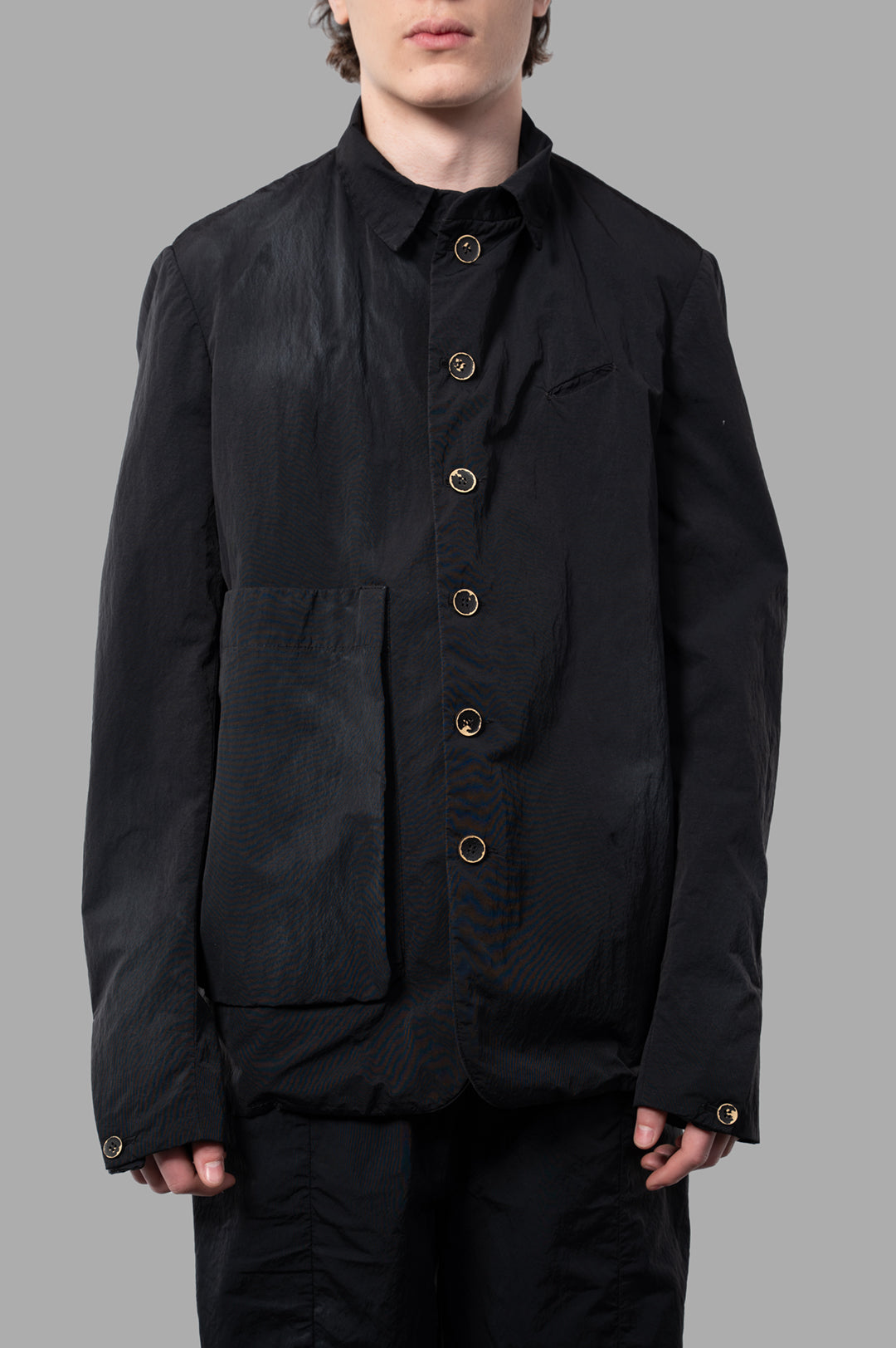 Marc Point Oversized Cargo Jacket in black, featuring a button-front, pocket detail, and modern, crinkled nylon fabric.