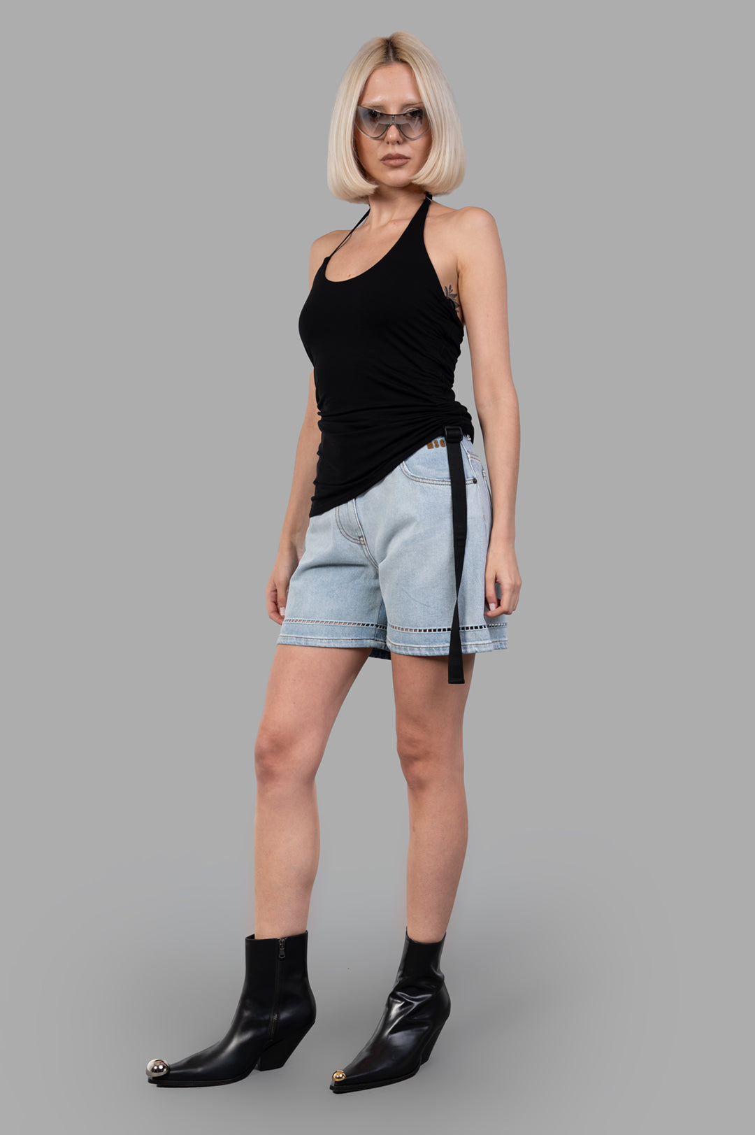 Helmut Lang Wind Harness Top, black halter-neck, on-model, front view. Soft lyocell jersey with seatbelt strap detail.