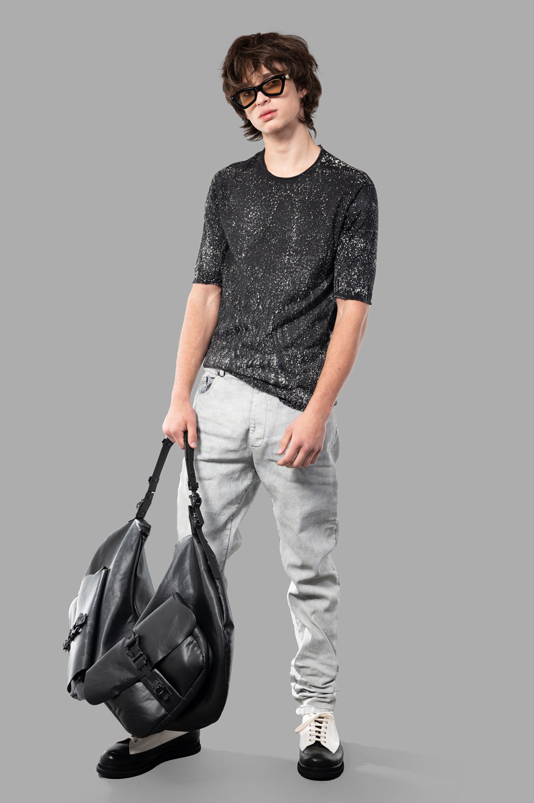 MD 75 Coated Jeans in white, modeled. Crafted in Italy with a blend of cotton and elastane for avant-garde style.