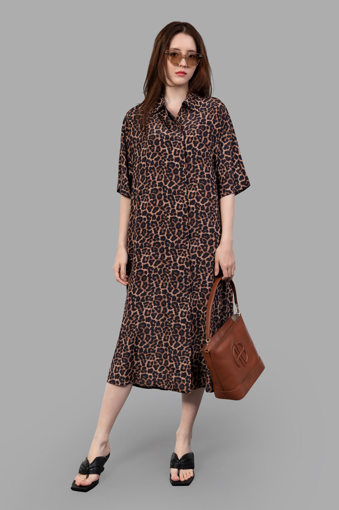 Anine Bing Julia Leopard Dress modeled with classic collar, short sleeves, and all-over leopard pattern, front view.