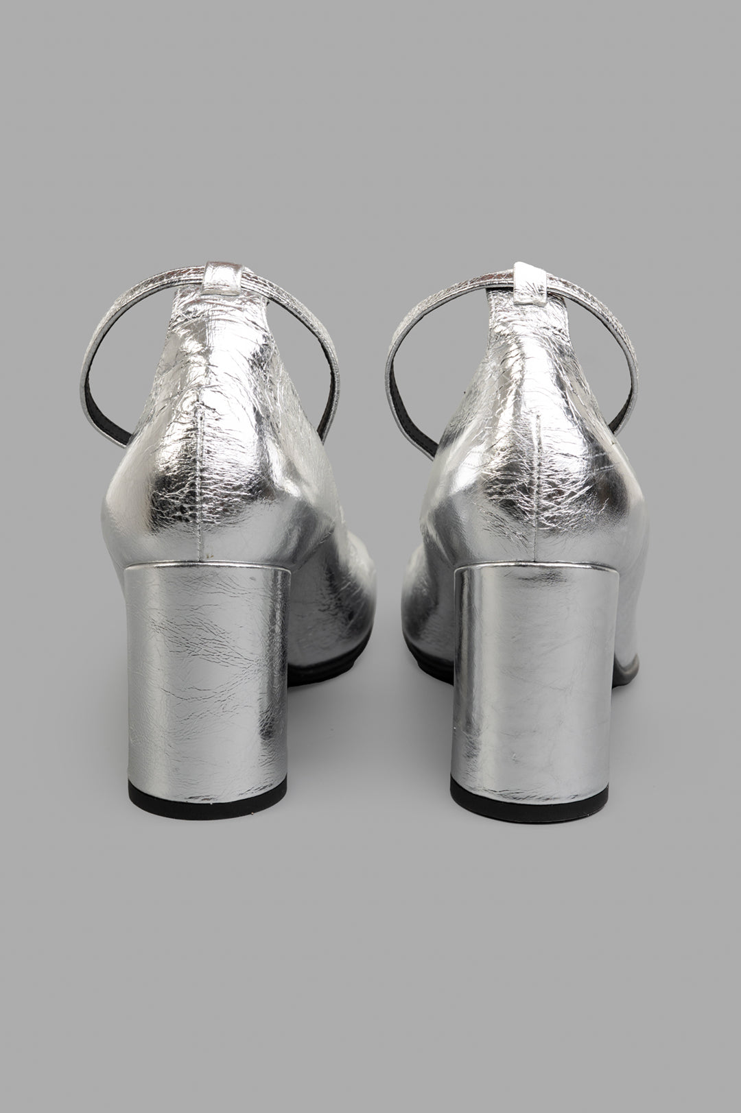 Mattia Capezzani Silver Heels featuring a sculptural back view, highlighting the metallic leather finish and block heel.