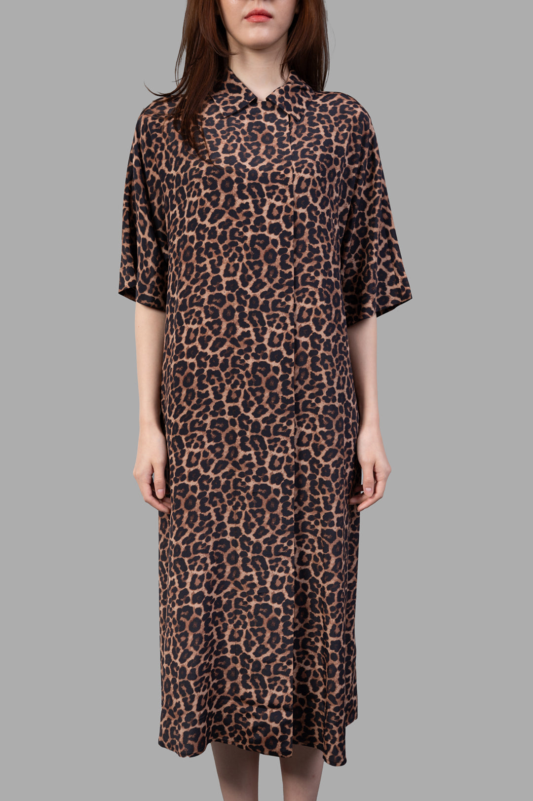 Anine Bing Julia Leopard Dress shown on model, featuring a sleek silhouette and short sleeves in a bold leopard print.