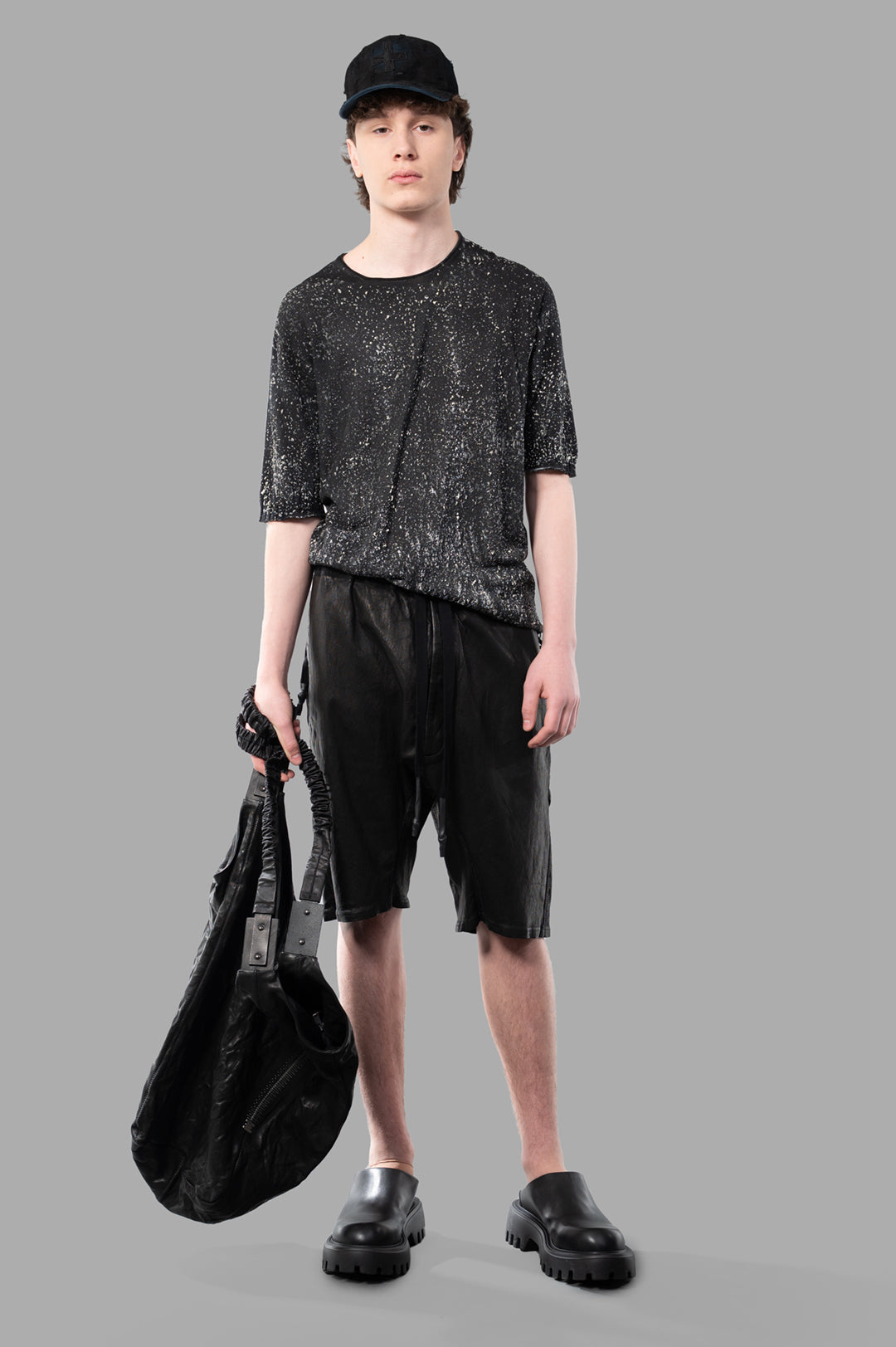 MD 75 Airbrushed Sweater in Grey, front view on-model, styled with black shorts and bag, against a grey background.