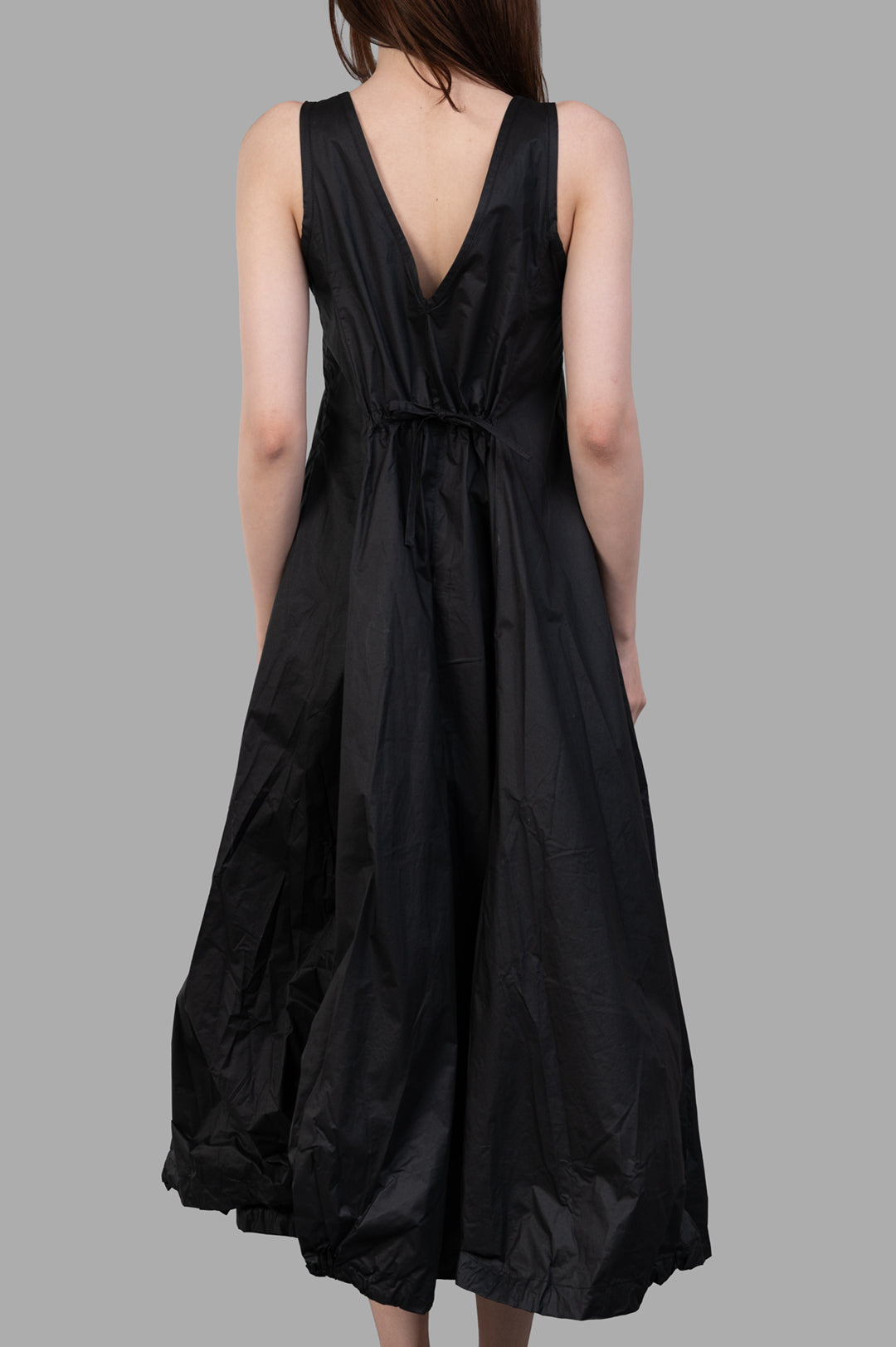Masnada Balloon Dress viewed from the back, featuring a V-neckline and gathered waist for a voluminous silhouette.
