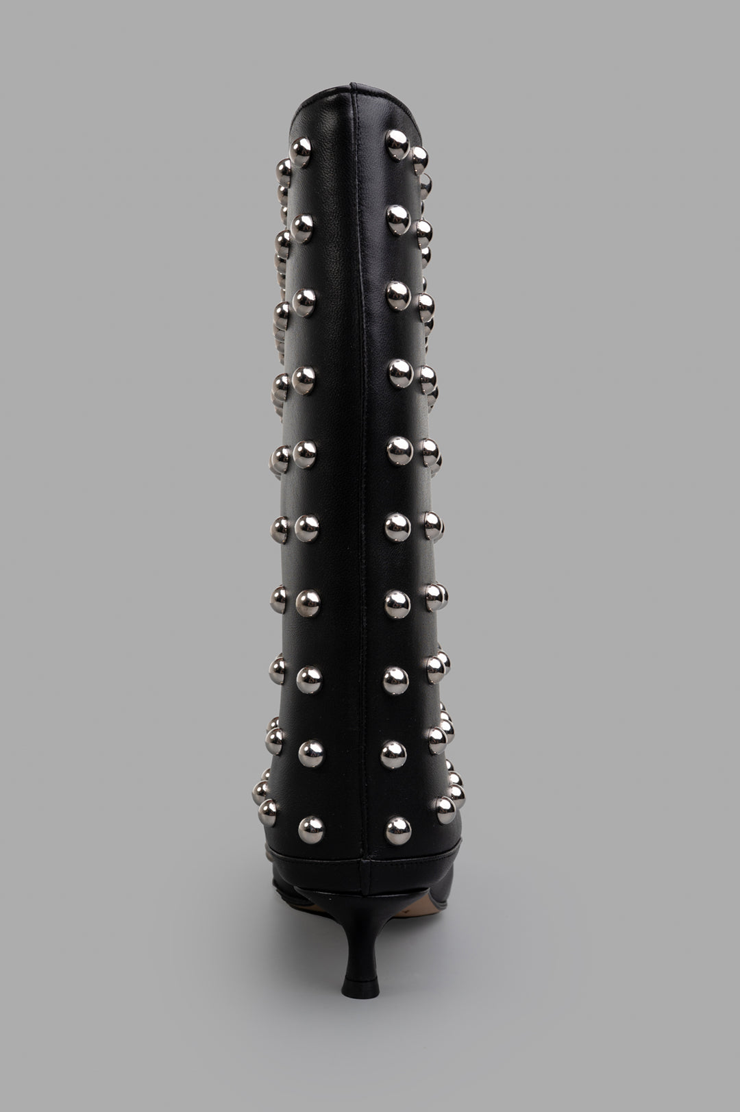 A.W.A.K.E. MODE Cylinder Boots featuring studded mid-calf design and a sleek pointed toe, shown from the back.