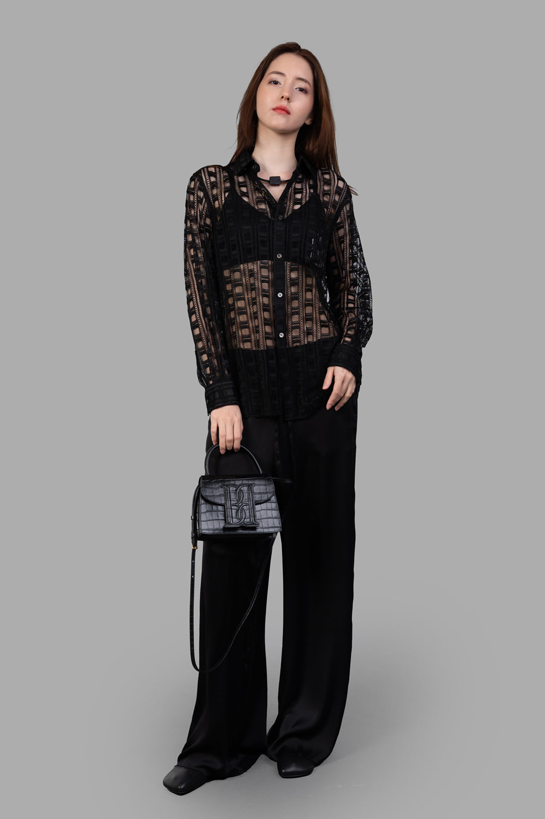 Comme des Garçons embroidered shirt in black, on-model front view, featuring button fastening and chest pocket.
