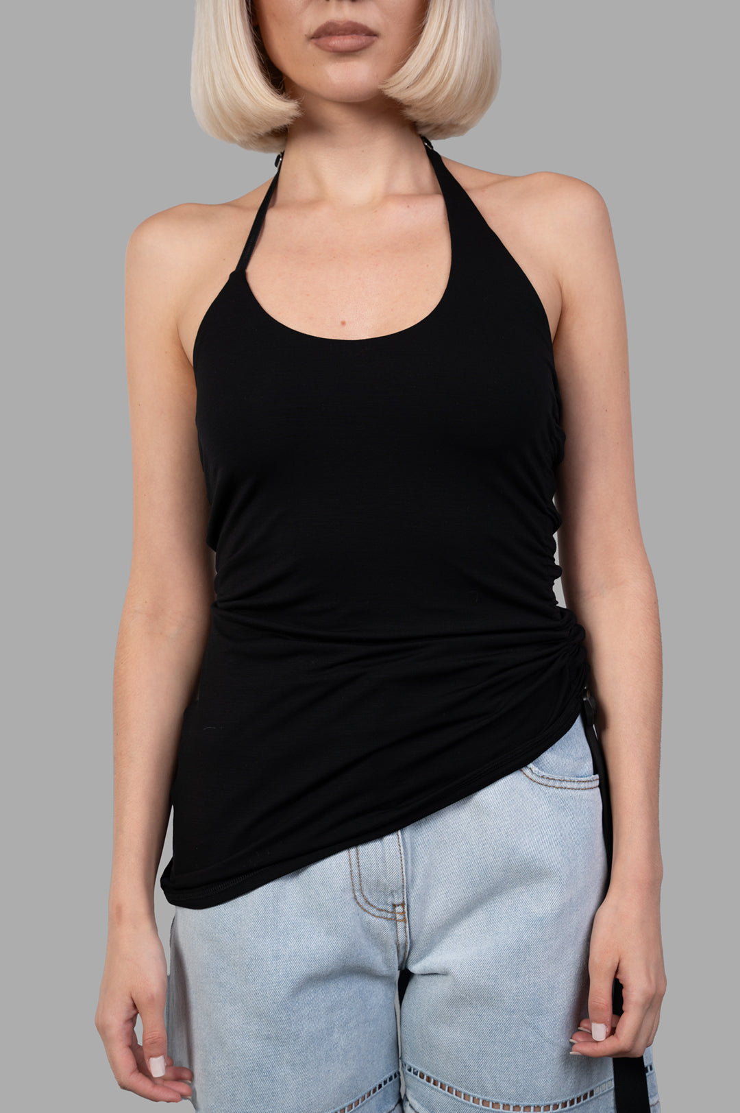 Helmut Lang Wind Harness Top showcases a black halter-neck style in soft lyocell jersey with a draped silhouette.