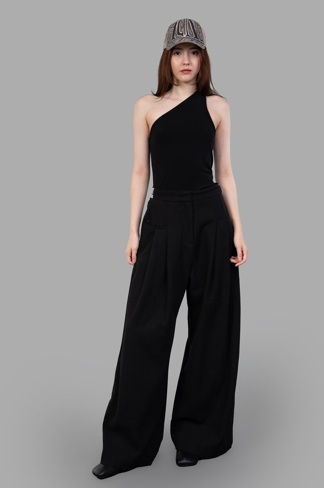 Giovanni Cavagna Wide-leg Trousers, front view on model, featuring black linen fabric, paired with a stylish black top.