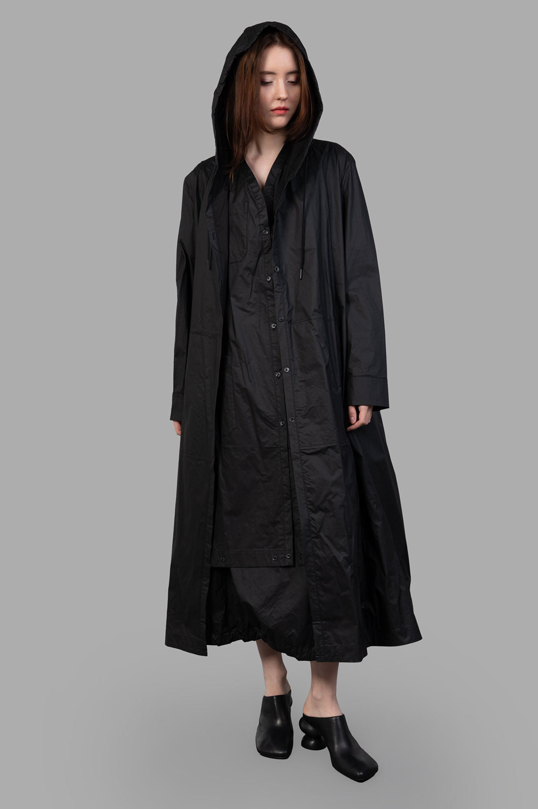 Masnada 2-in-1 Parka, black hooded long coat, front view on-model, button-front with drawstrings, ankle-length