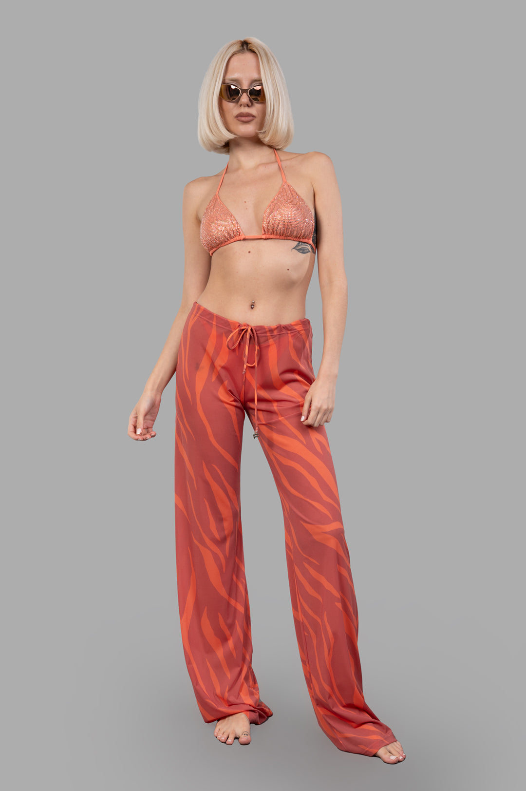 Fisico Zebra-print Trousers in coral, side view on model, featuring a bold, luxurious pattern and impeccable cut.