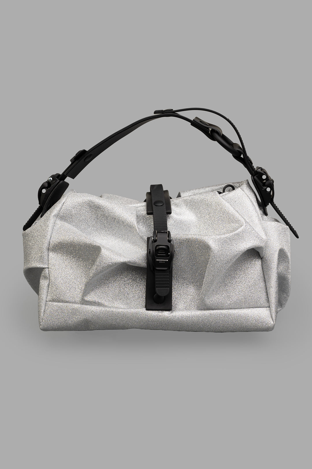 Innerraum Silver Bag I96 front view, showcasing textured technical material and bold, futuristic design elements.