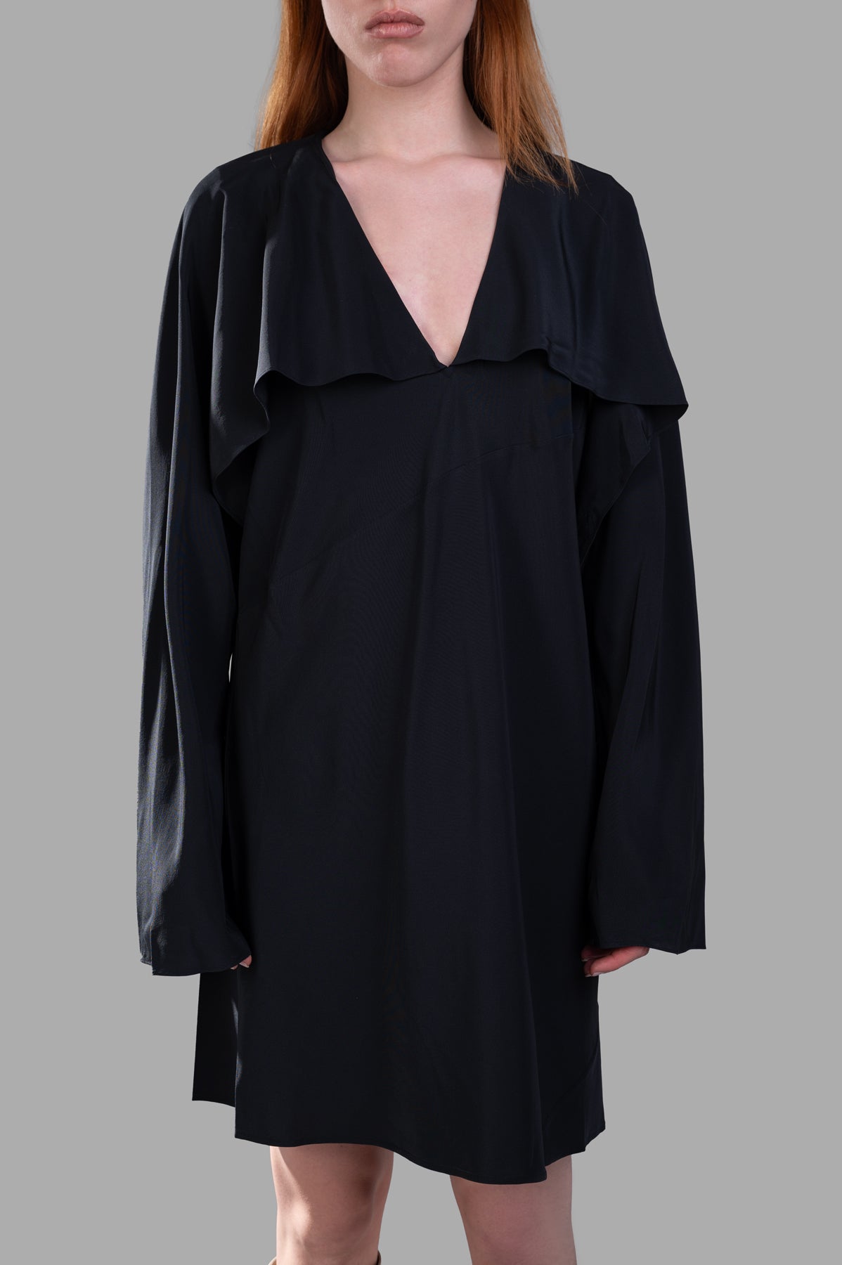 Helmut Lang Scarf Dress in luxurious black silk with a striking deep V neck, displayed on model from a three-quarter angle.