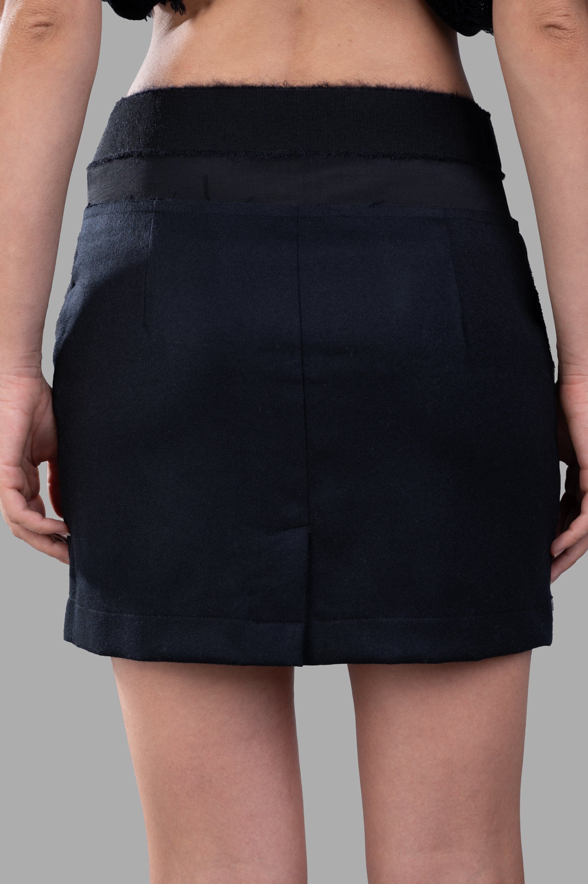 Giovanni Cavagna Mini Furry Skirt, back view showcasing the high-waisted design and luxurious furry texture in black.
