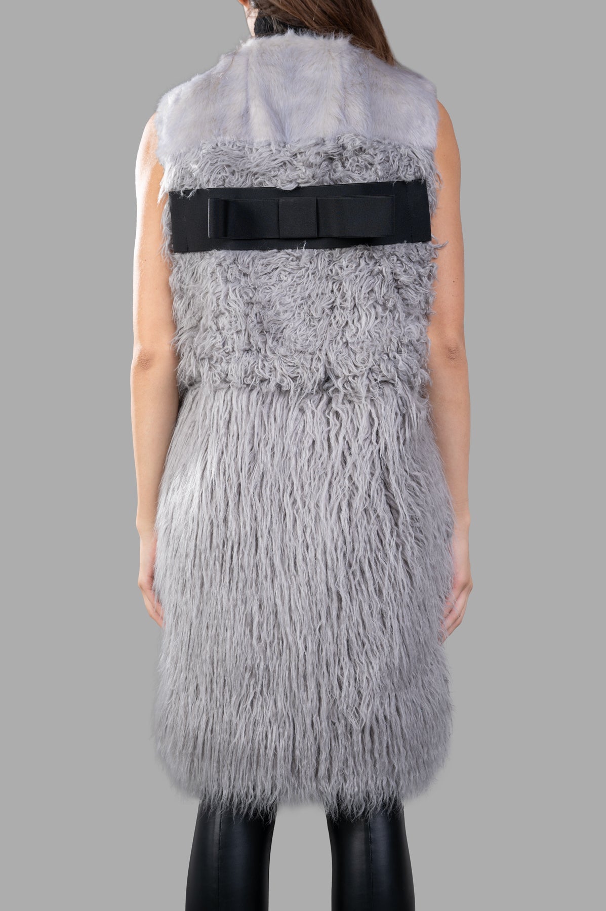 Alabama Muse Faux-fur Vest shown from the back, featuring a textured grey design with a stylish black bow detail.