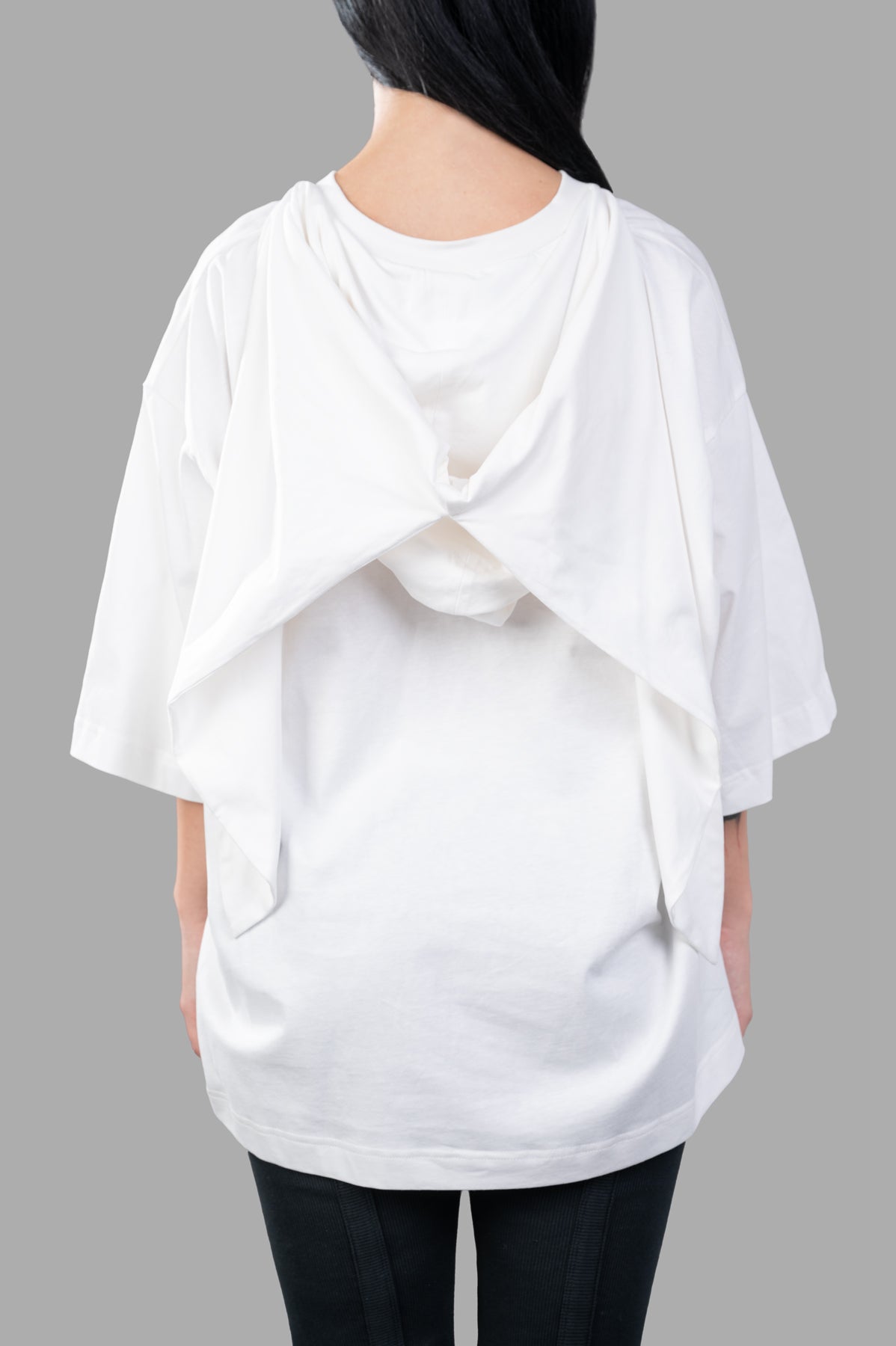 Natasha Zinko White Bandit T-shirt, oversized style with a unique built-in hood, showcased from the back view.