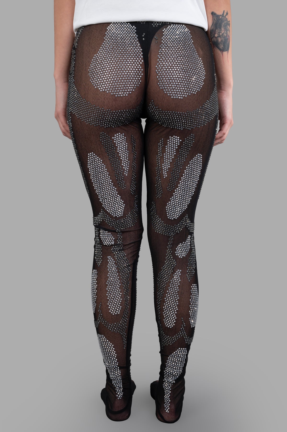 Natasha Zinko Rhinestones Embellished Leggings featuring a sheer design with sparkling rhinestones, showcased from the back.