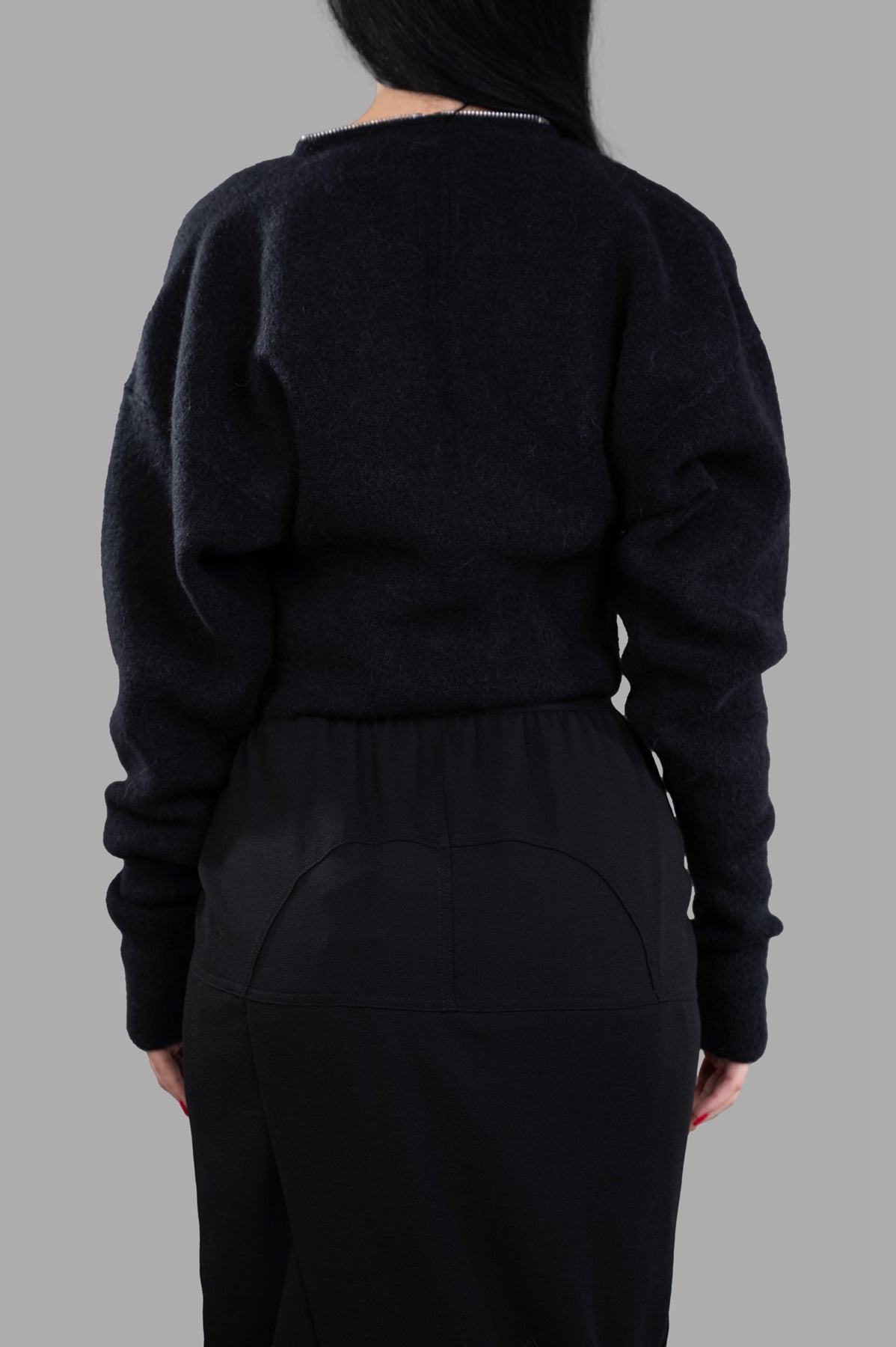 Rick Owens Cropped Cardigan in black, featuring batwing sleeves and a zippered Klaus V-neck design, shown from the back.