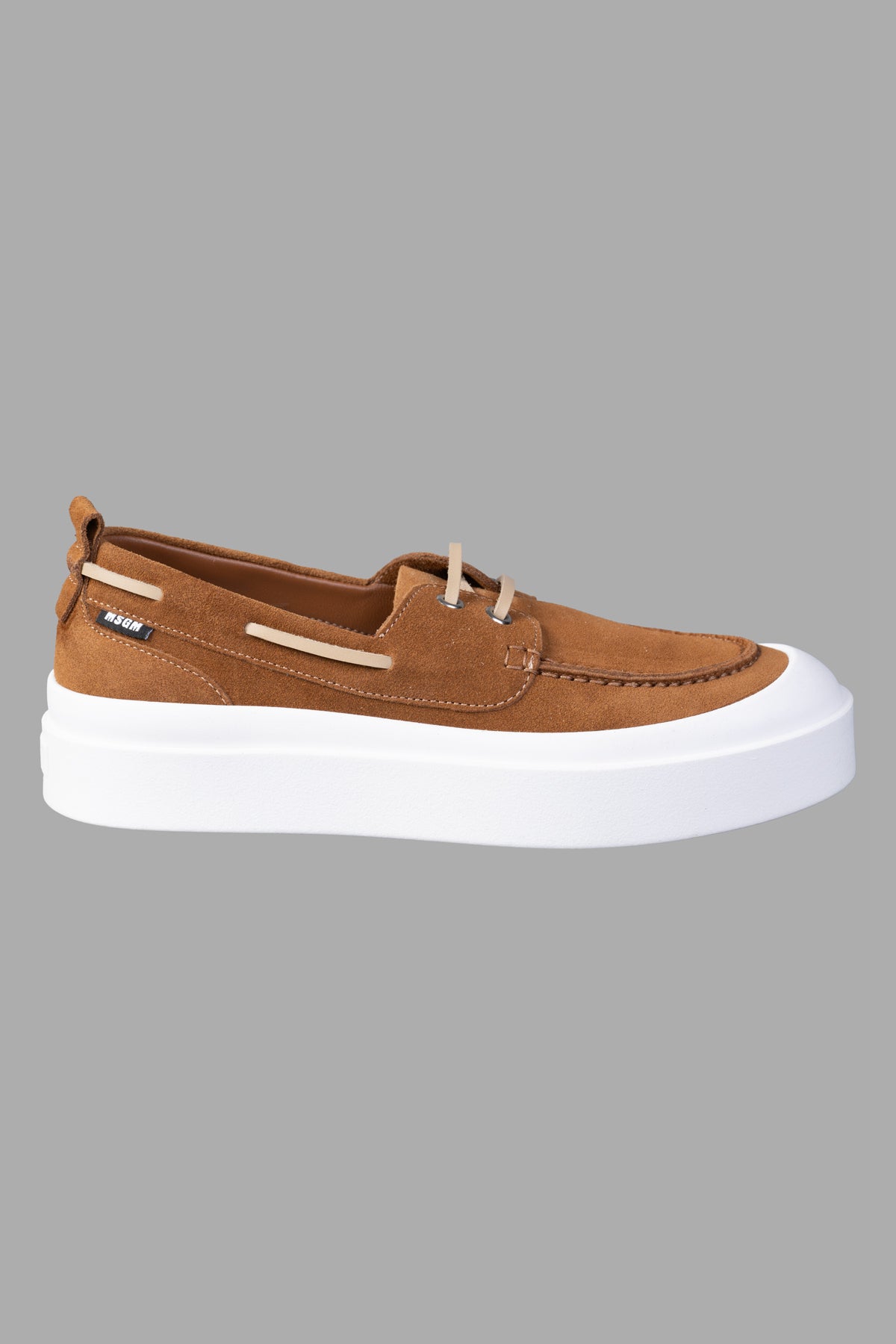 MSGM Suede Loafers in brown, side view. Features lace-up front, contrasting toecap, and pull-tab on flat rubber sole.