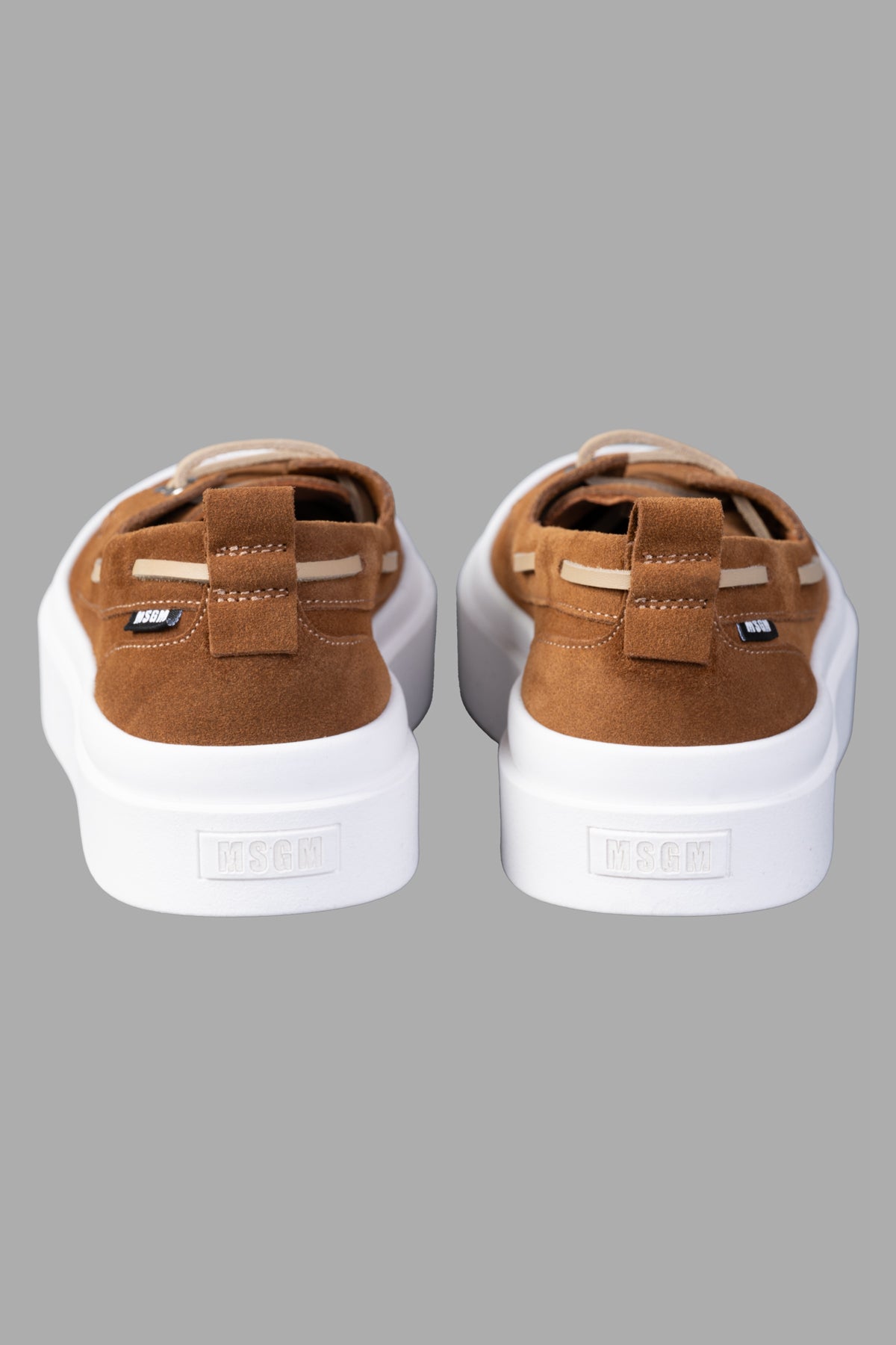 MSGM Suede Loafers featuring a back view showcasing the heel pull-tab and flat rubber sole, crafted in soft brown suede.