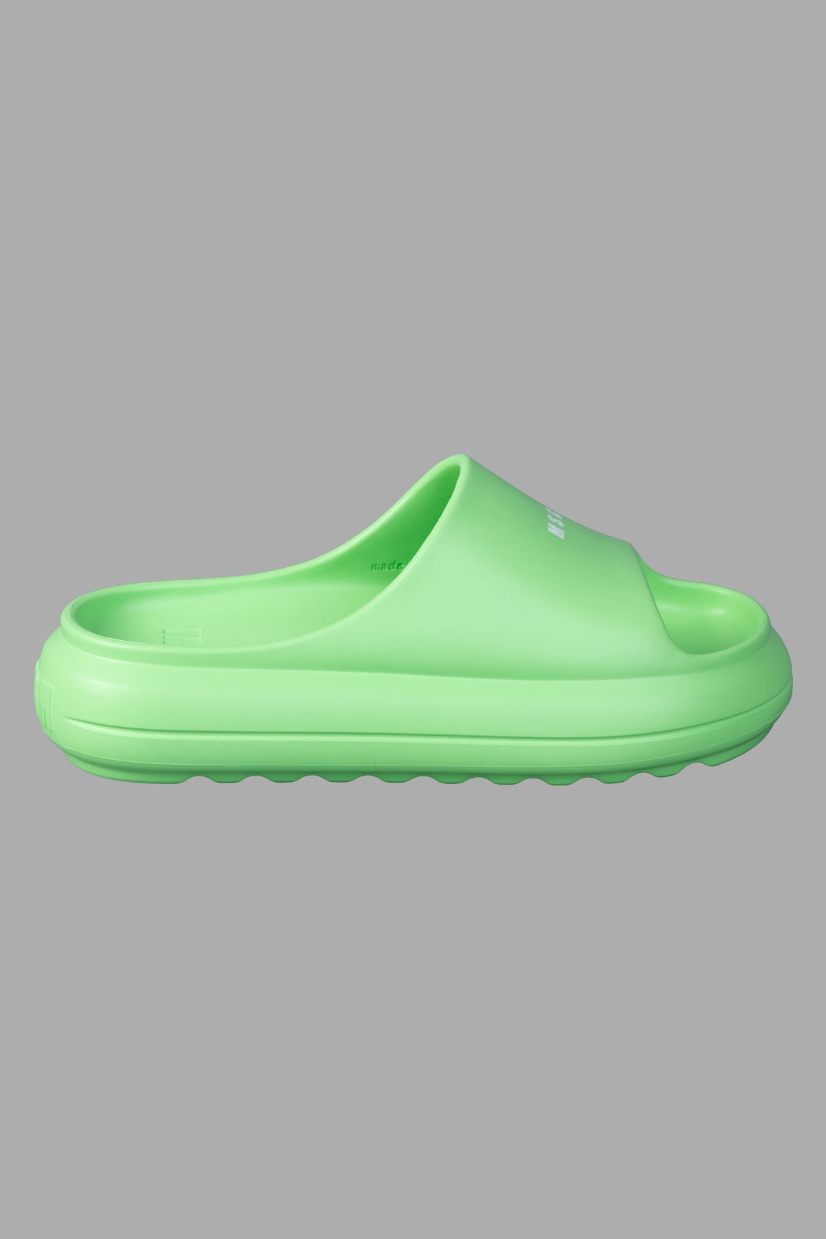 MSGM Ocean Club Sliders, side view. Bold green rubber slides, featuring signature logo. Trendy summer footwear.