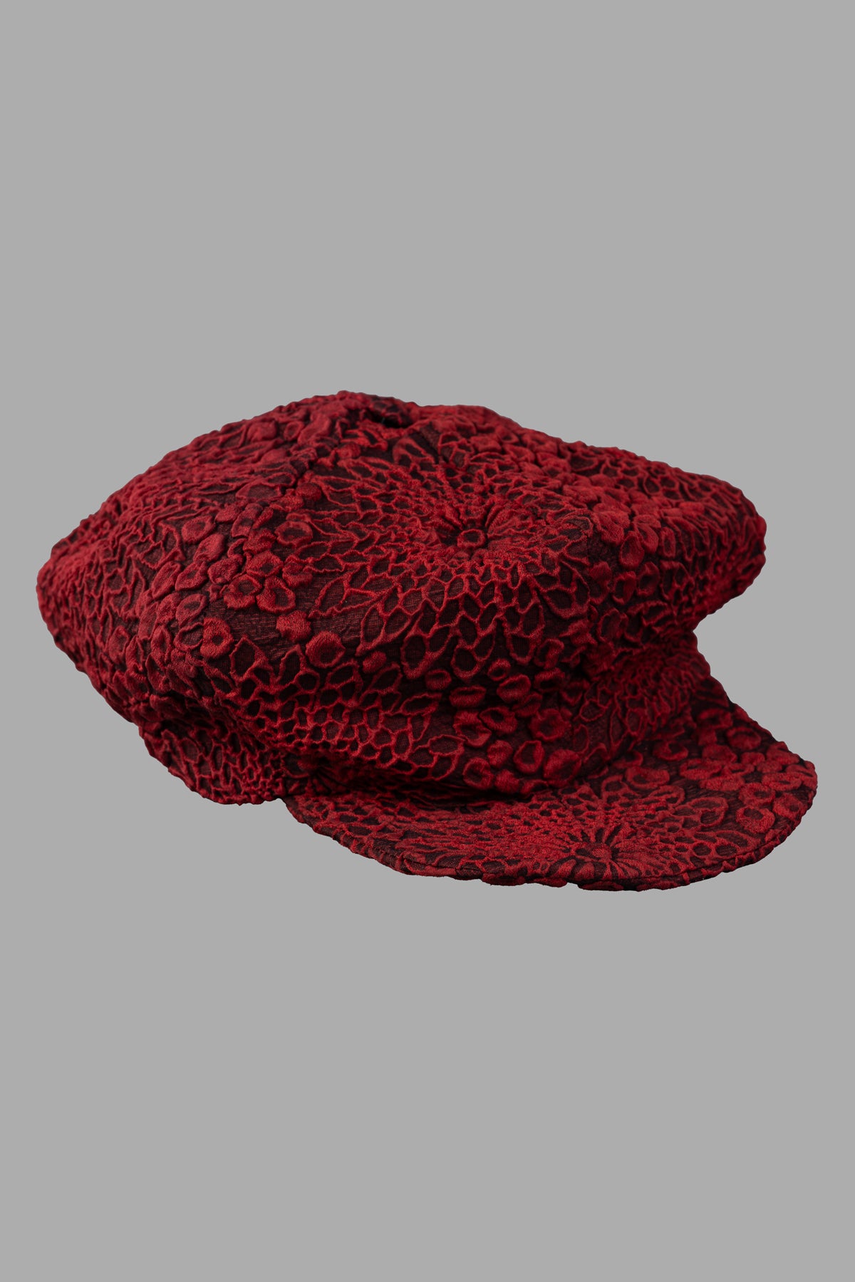 Marc Point Panelled Hat with Peak, front view, features textured red floral print fabric, reinforced peak for structure.