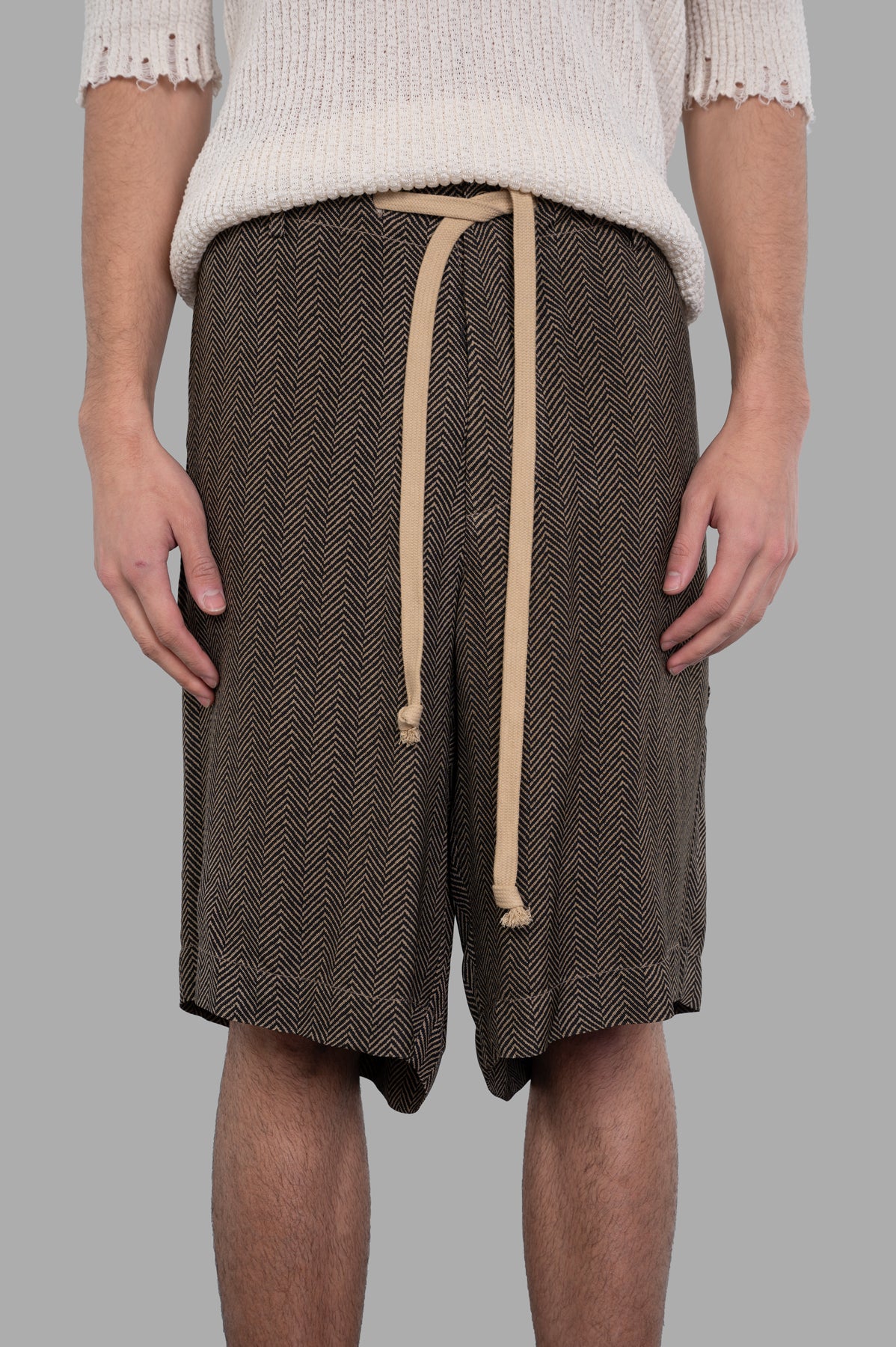 Uma Wang Herringbone Shorts with drawstring waist, showing the brown pattern and comfortable fit on model. Perfect for.