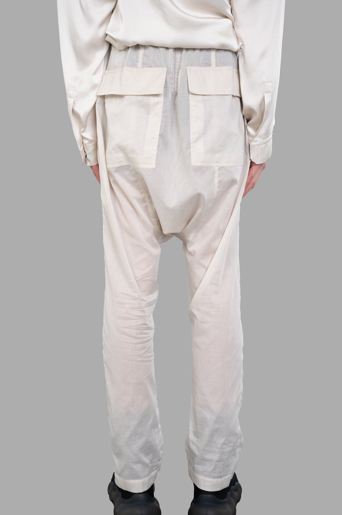 Rick Owens Semi-sheer Drawstring Pants, ecru, showcasing the back view with flapped pockets and textured fabric.