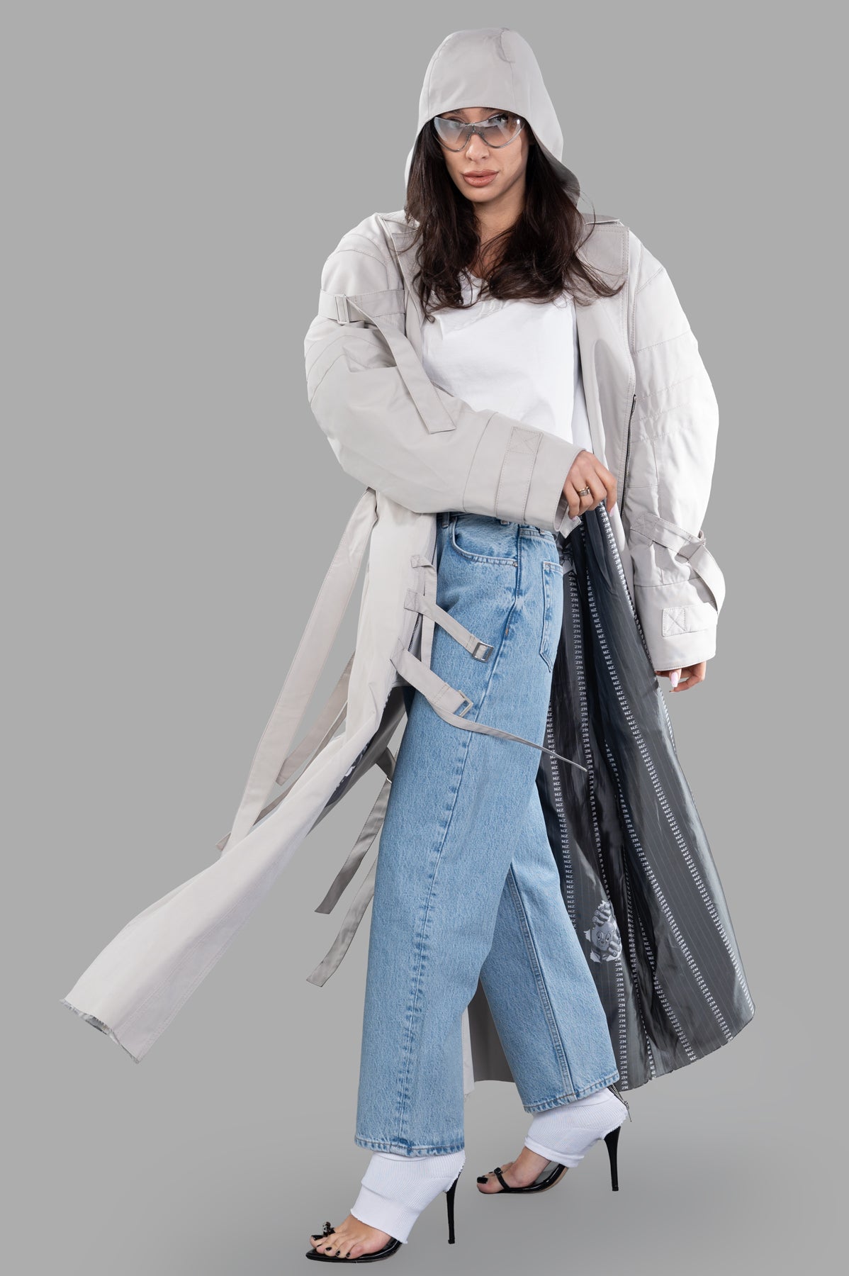 Natasha Zinko Strapped Trench coat in paneled cotton, featuring a hood, sleeve straps, and notched lapel, modeled front view.