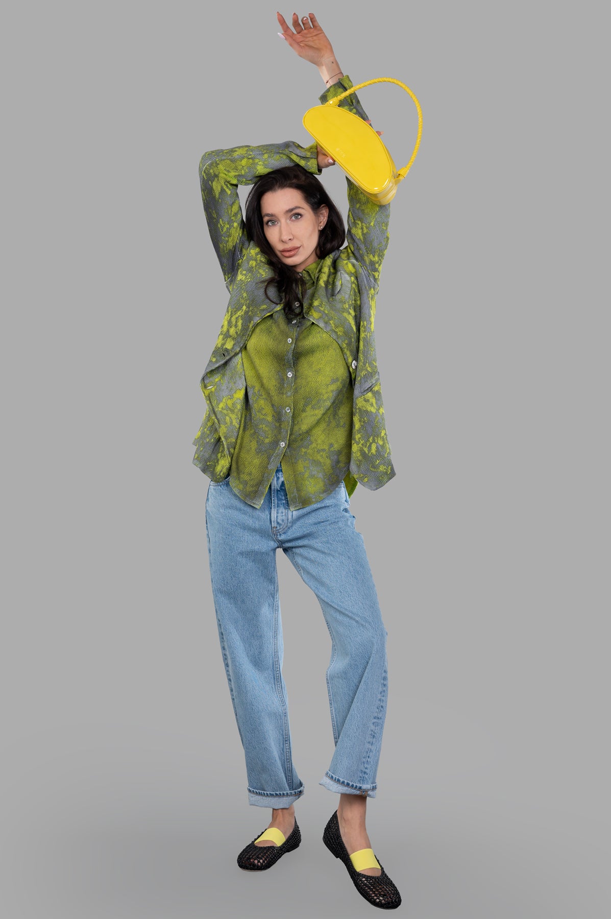 Avant Toi Camouflage Silk Blazer front view on-model, arms raised, styled with blue jeans and yellow handbag.