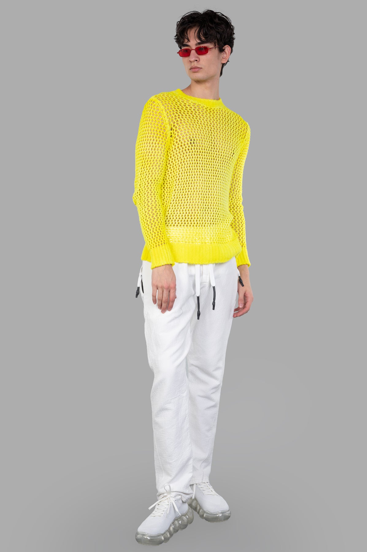 Avant Toi open-knit sweater in bright yellow, front view on model. Crew neck design with ribbed cuffs for stylish layering.